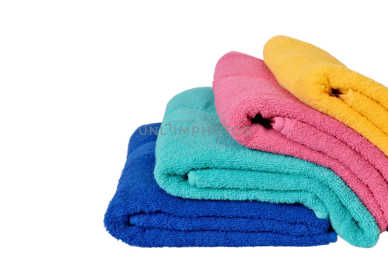 Pile colorful towels isolated over white background