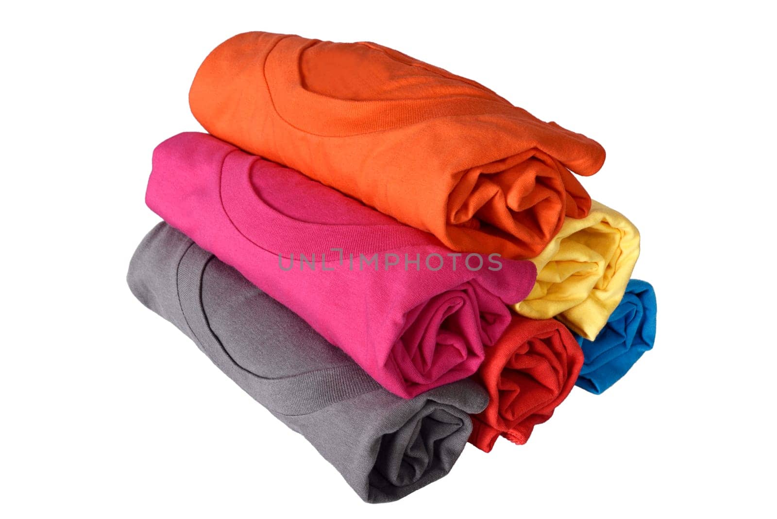 Pile of rolled colorful clothes isolated over white background