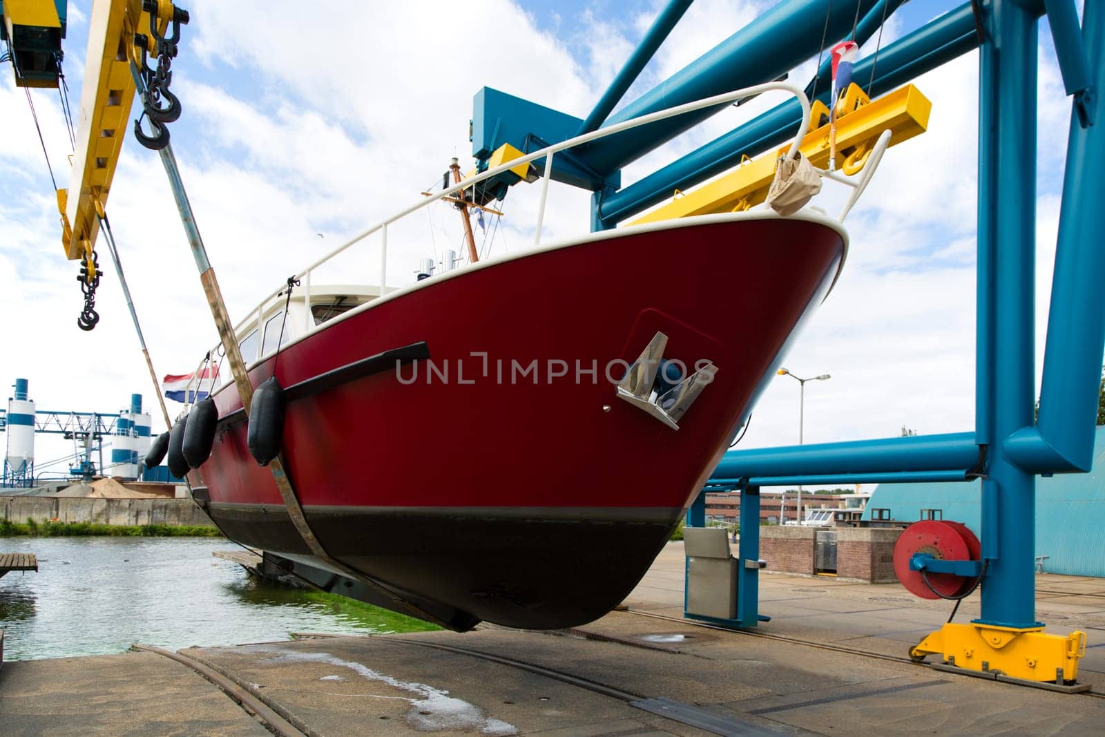 Boat crane lifting a motorboat.