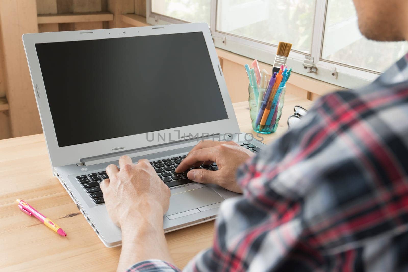 Black Scott shirt businessman typing laptop or notebook in home office. Small business SME or start up businessman concept. Business and technology about communication or contact