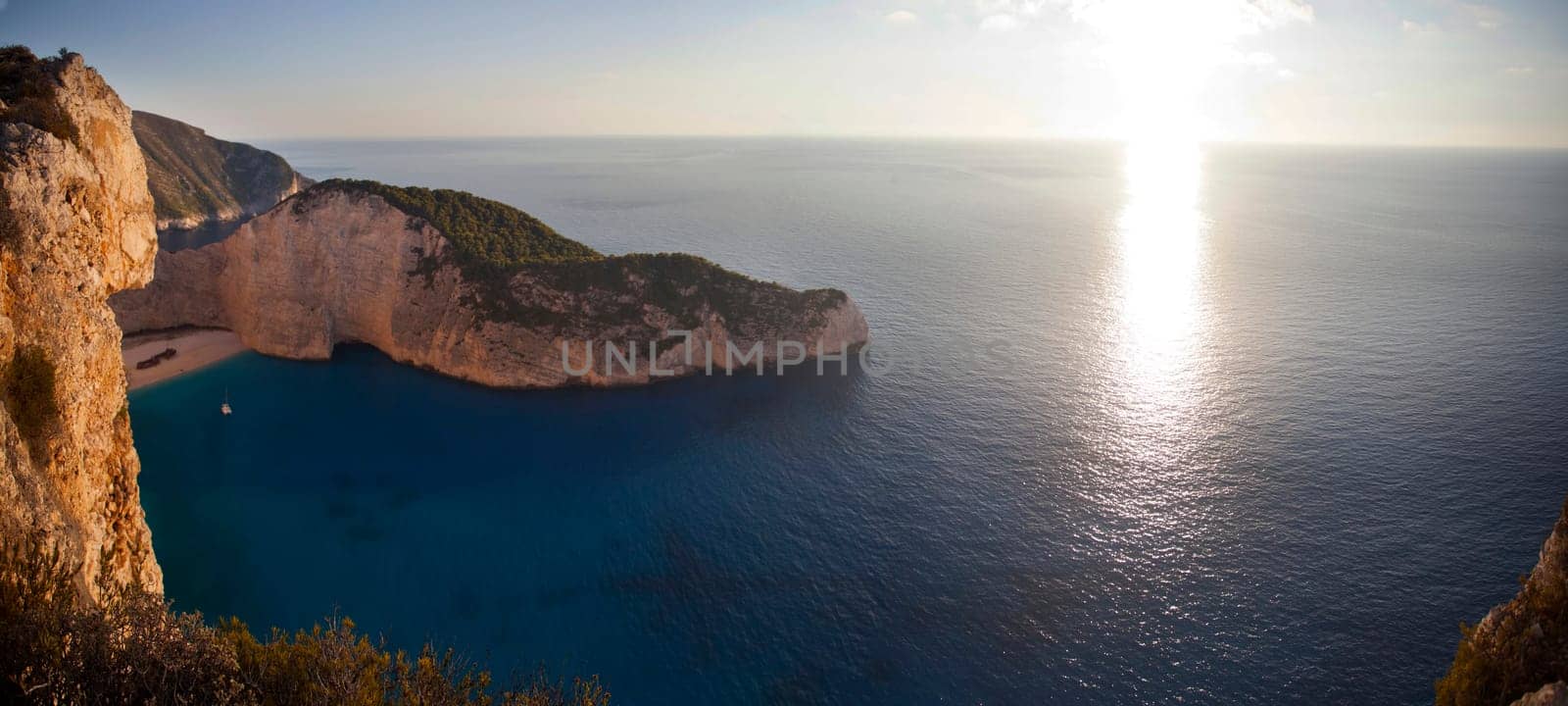 Navagio beach with shipwreck against sunset on Zakynthos island in Greece