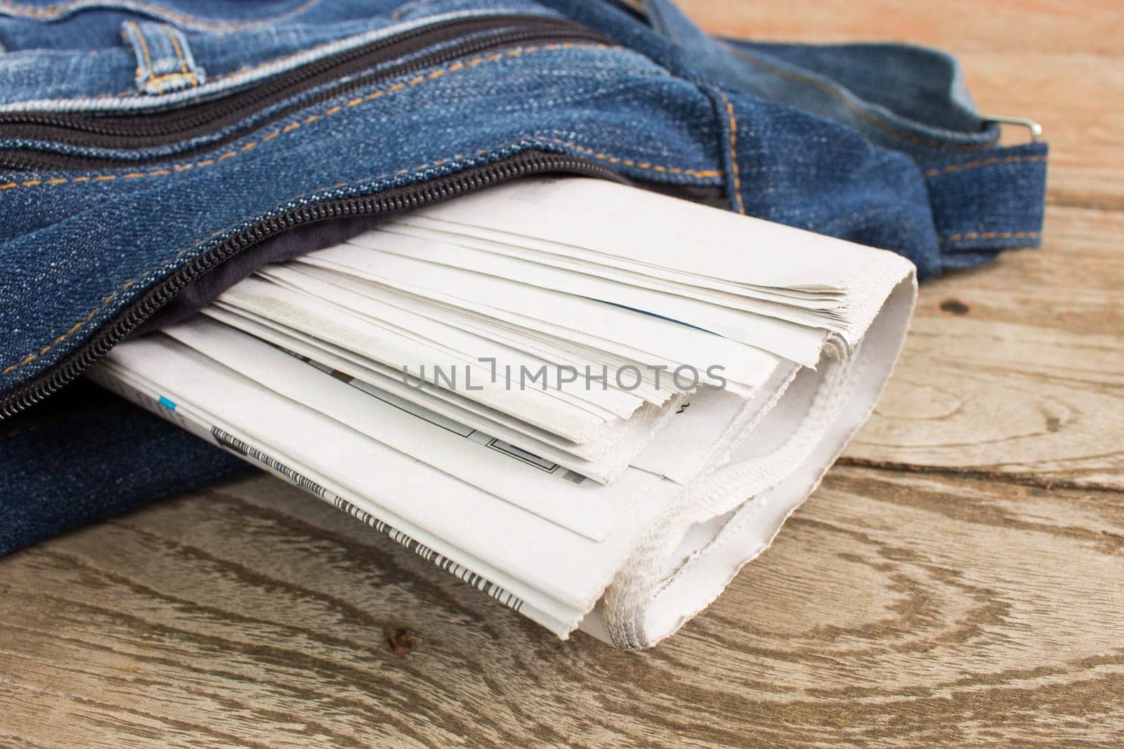 Newspaper in Newspaper Bag on Wood Concept about Journalist or Business. Foreign Newspaper background
