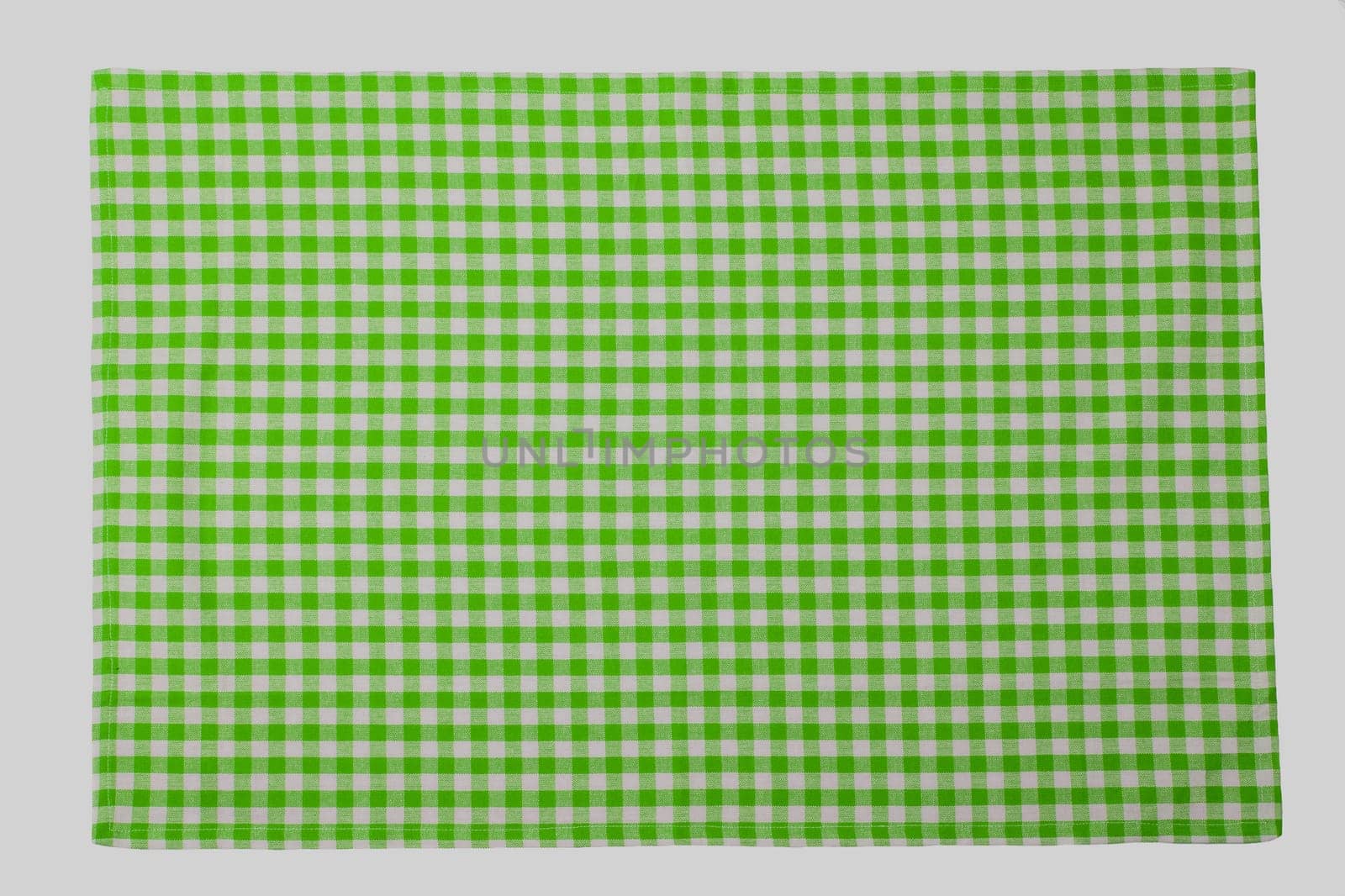 Green and white checkered napkin isolated on white background.