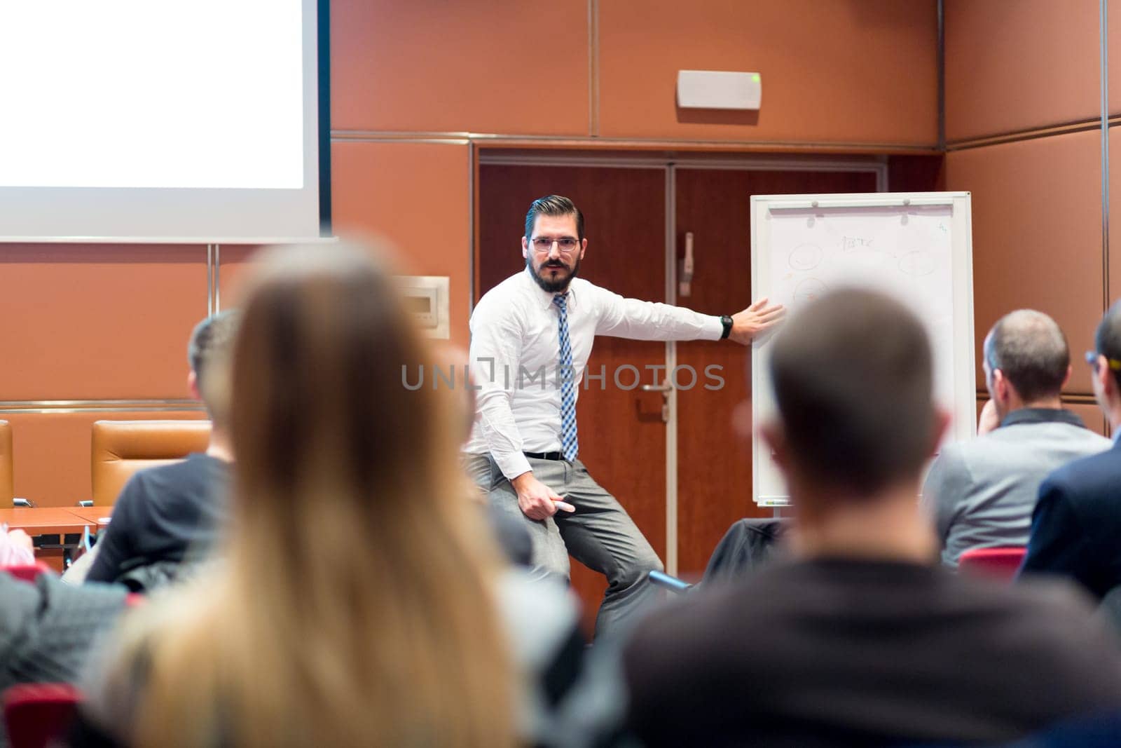 Speaker Giving a Talk at Business Meeting. Audience in the conference hall. Business and Entrepreneurship concept.