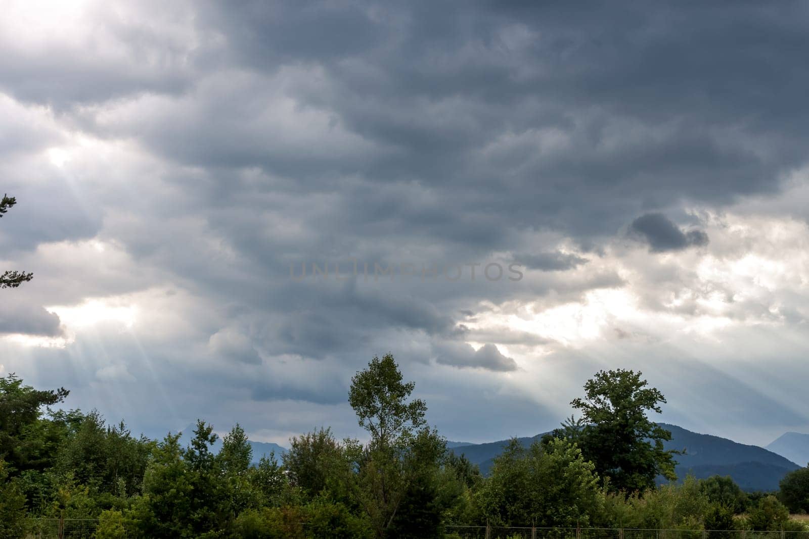 dramatic dark clouds and sun beams landscape
