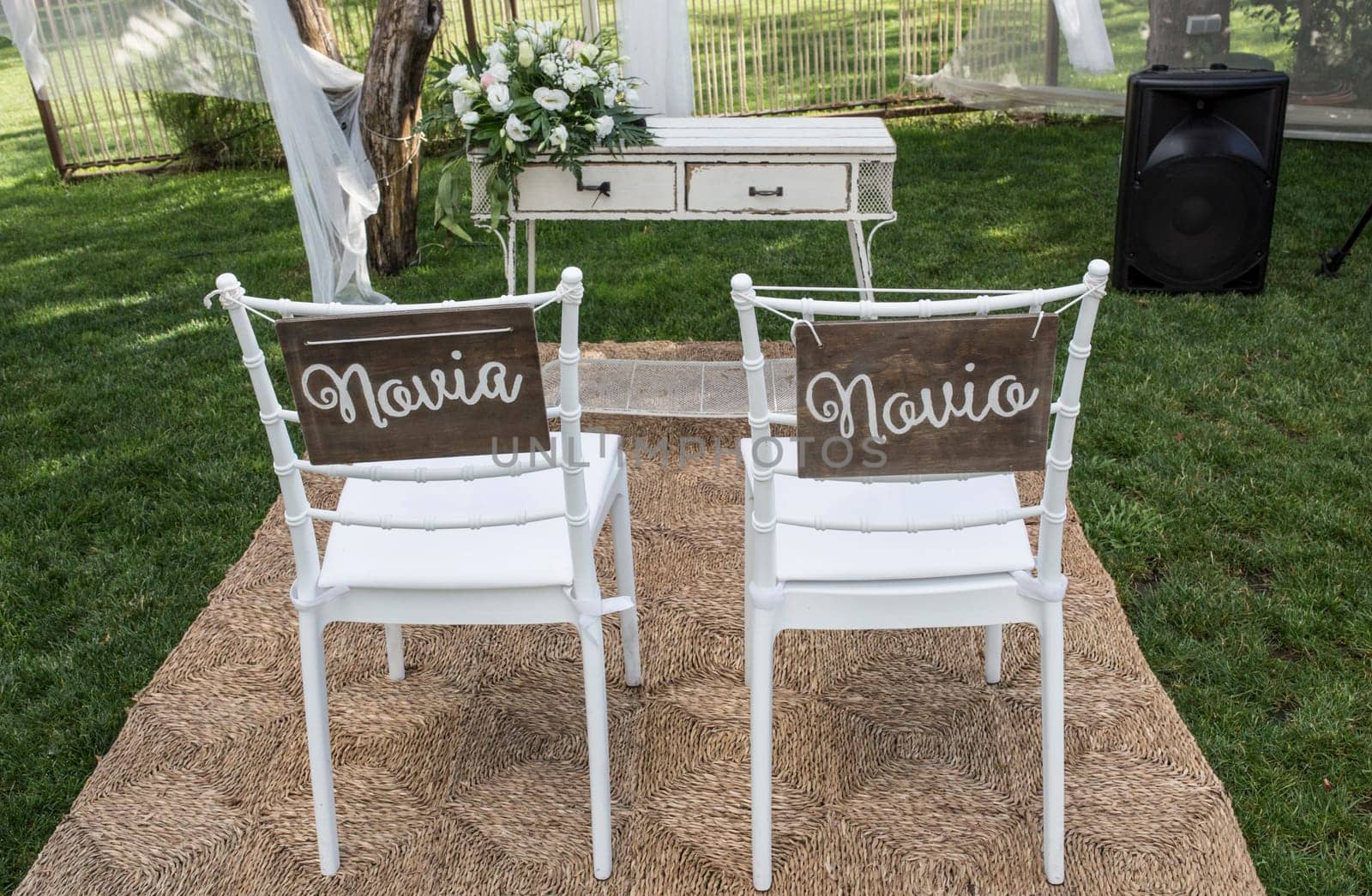 Chairs for bride and groom at altar. Spanish sign Novia y Novio