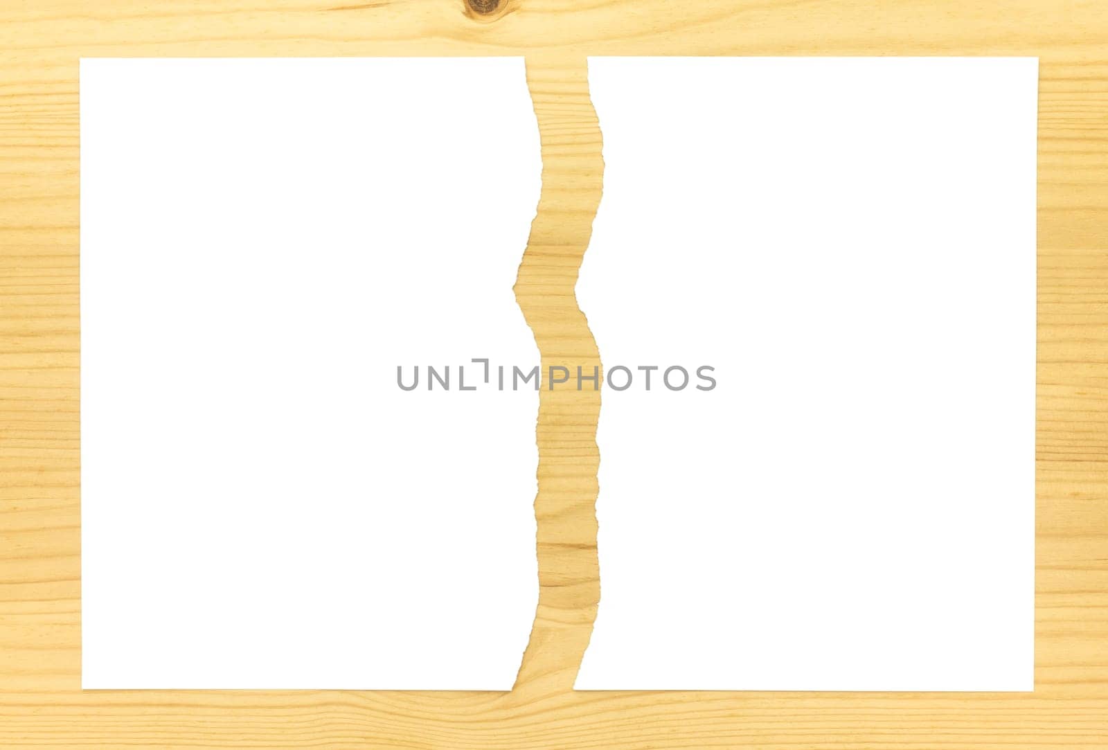 White Ripped Paper in Half on Wood Background. White torn paper 2 part for separate or partition or divide concept