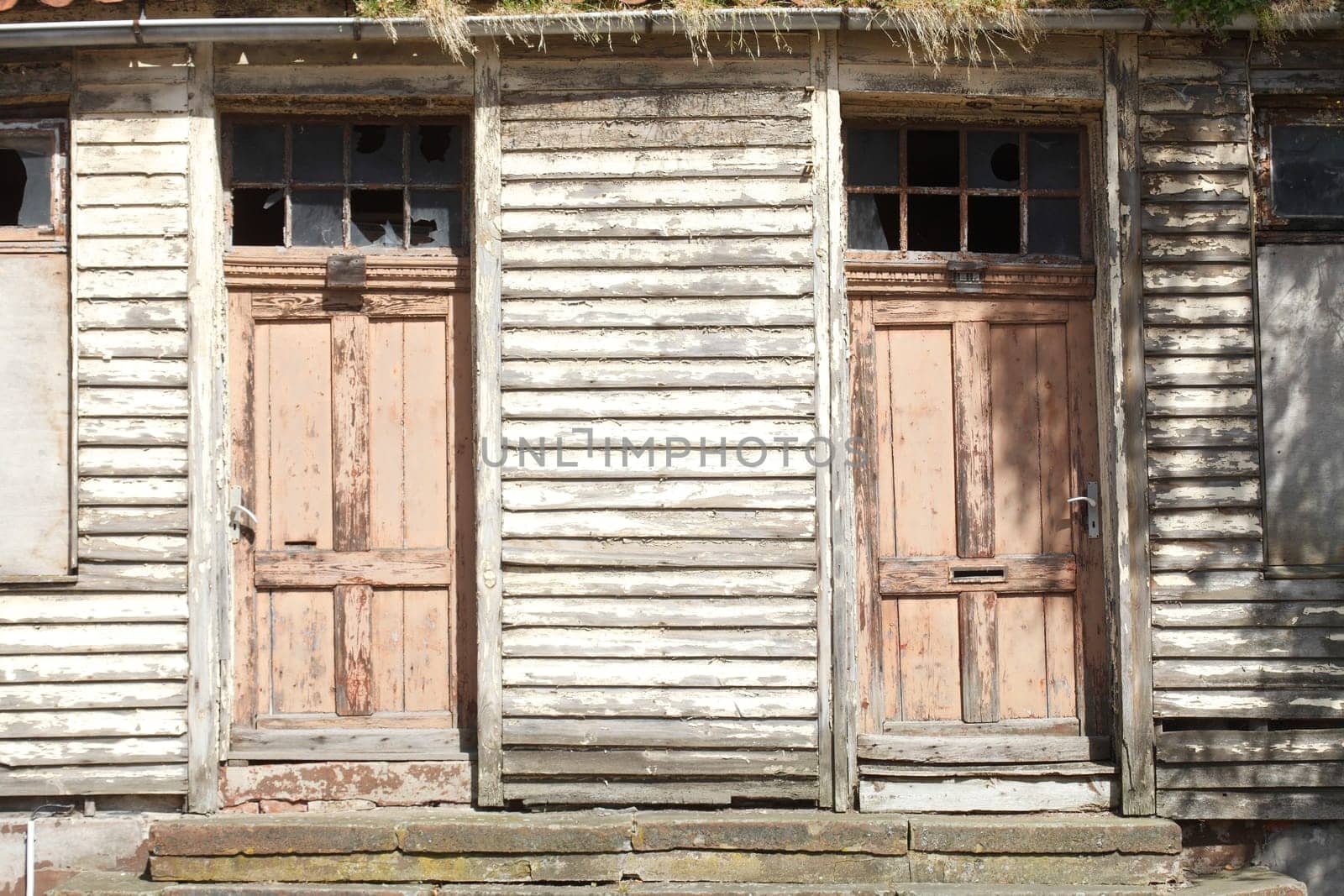 old doors on an old condemned wooden house