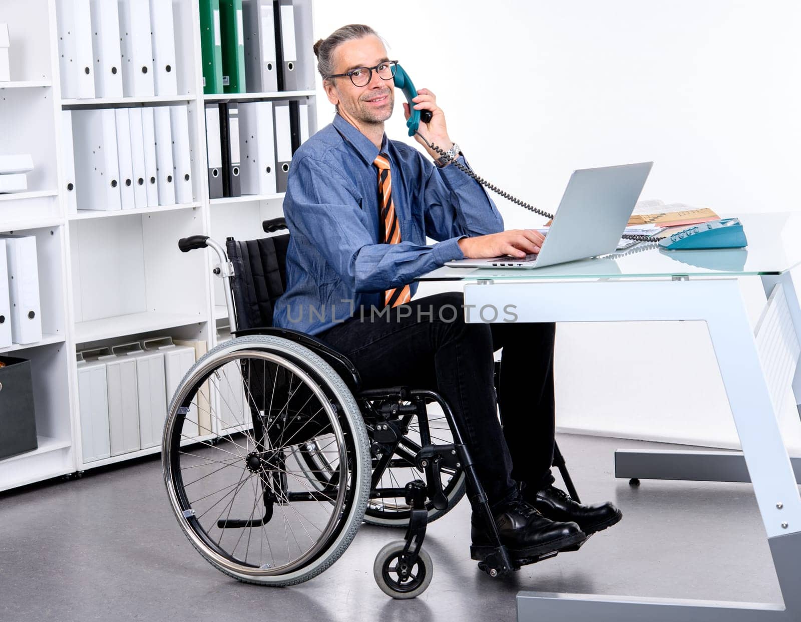 disabled business man in wheelchair working in the office