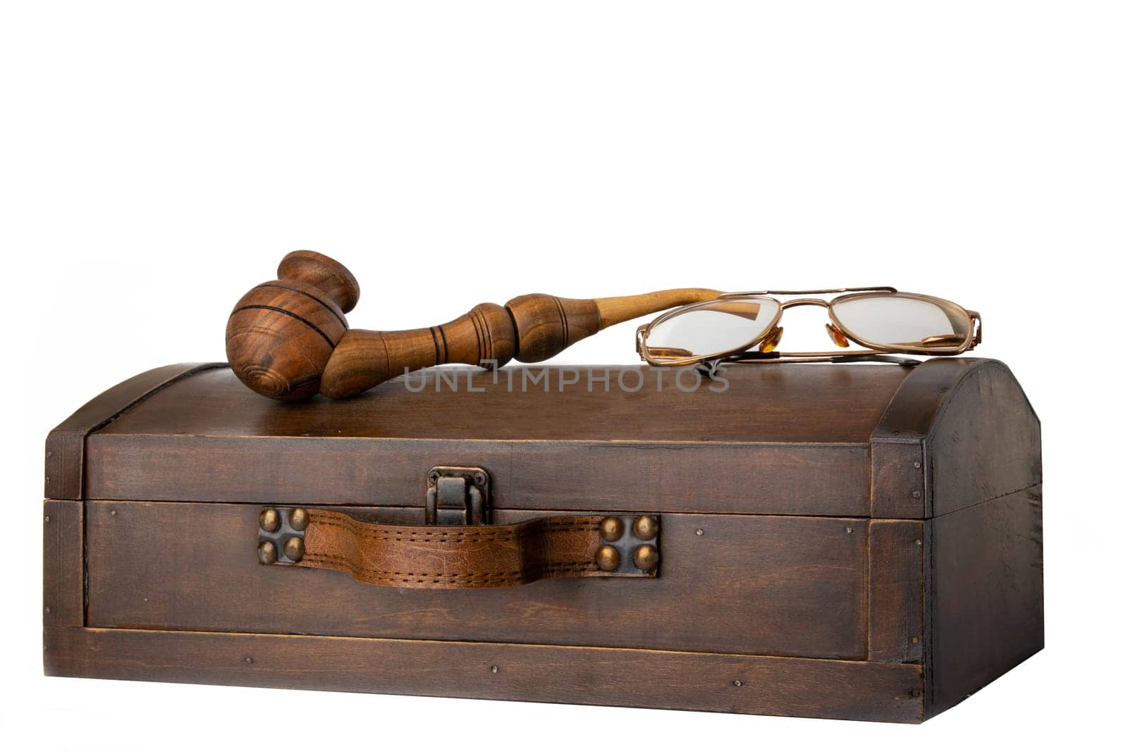 Old wooden chest with tobacco pipe and a pair of glasses on it isolated on white background.