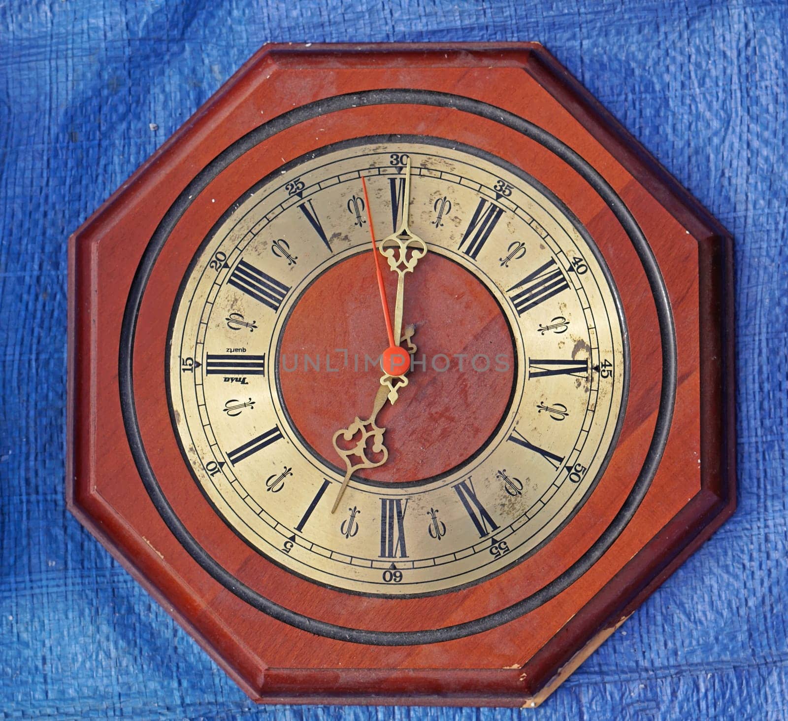 Octagonal wall clock with wood and brass