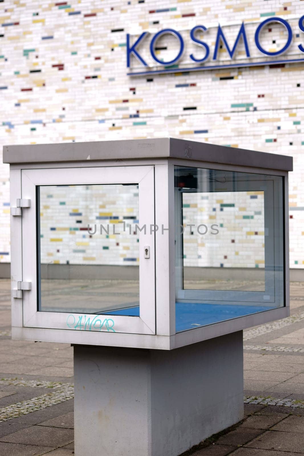 Berlin,Germany - July 13,2018: A glass showcase stands in front of the vintage façade of the well-known open-plan cinema and venue Kosmos in Berlin's Kreuzberg-Friedrichshain district on July 13,2018 in Berlin
