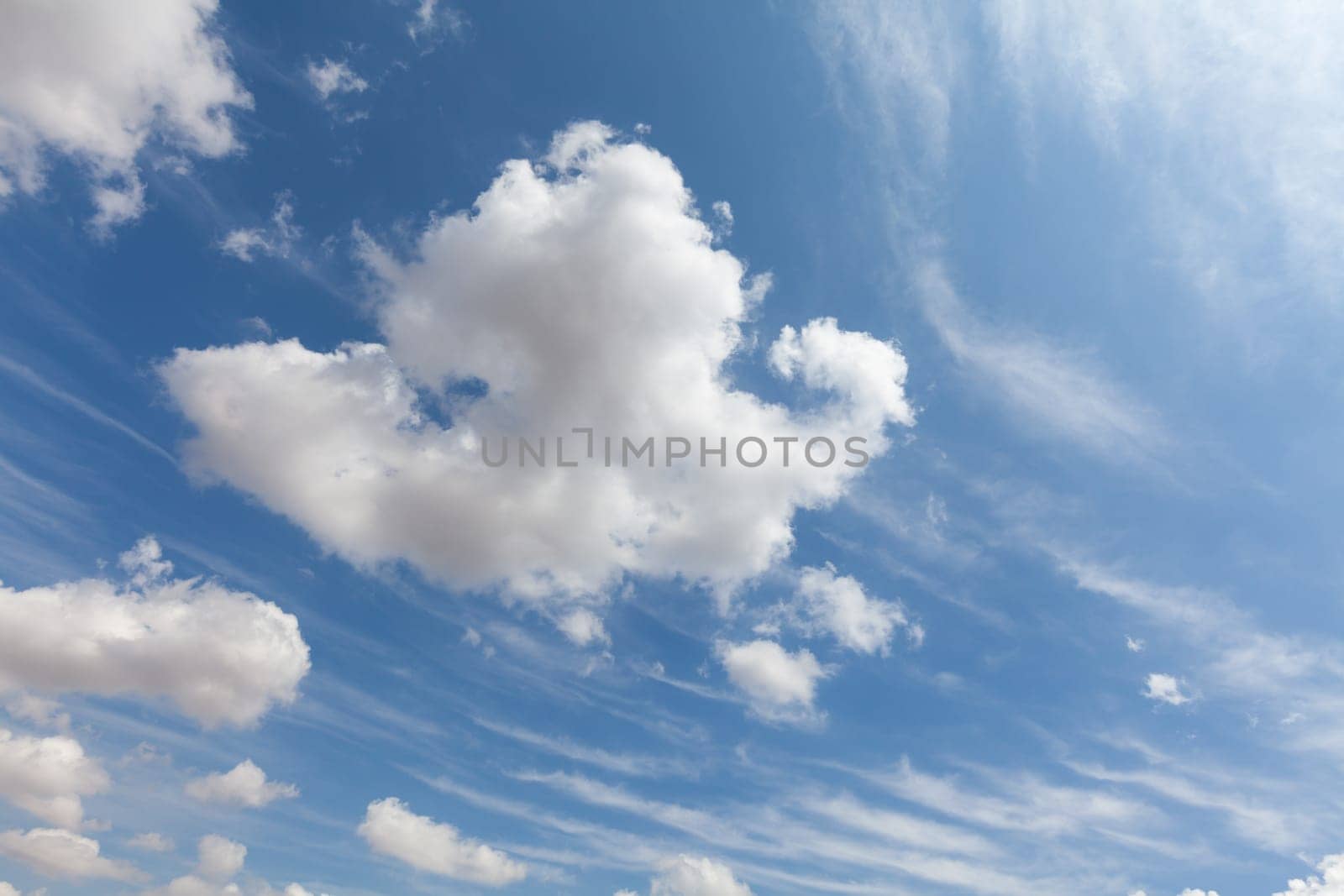 Beautiful white clouds and blue sky background over England UK. Fluffy and wispy cloudscape backdrop