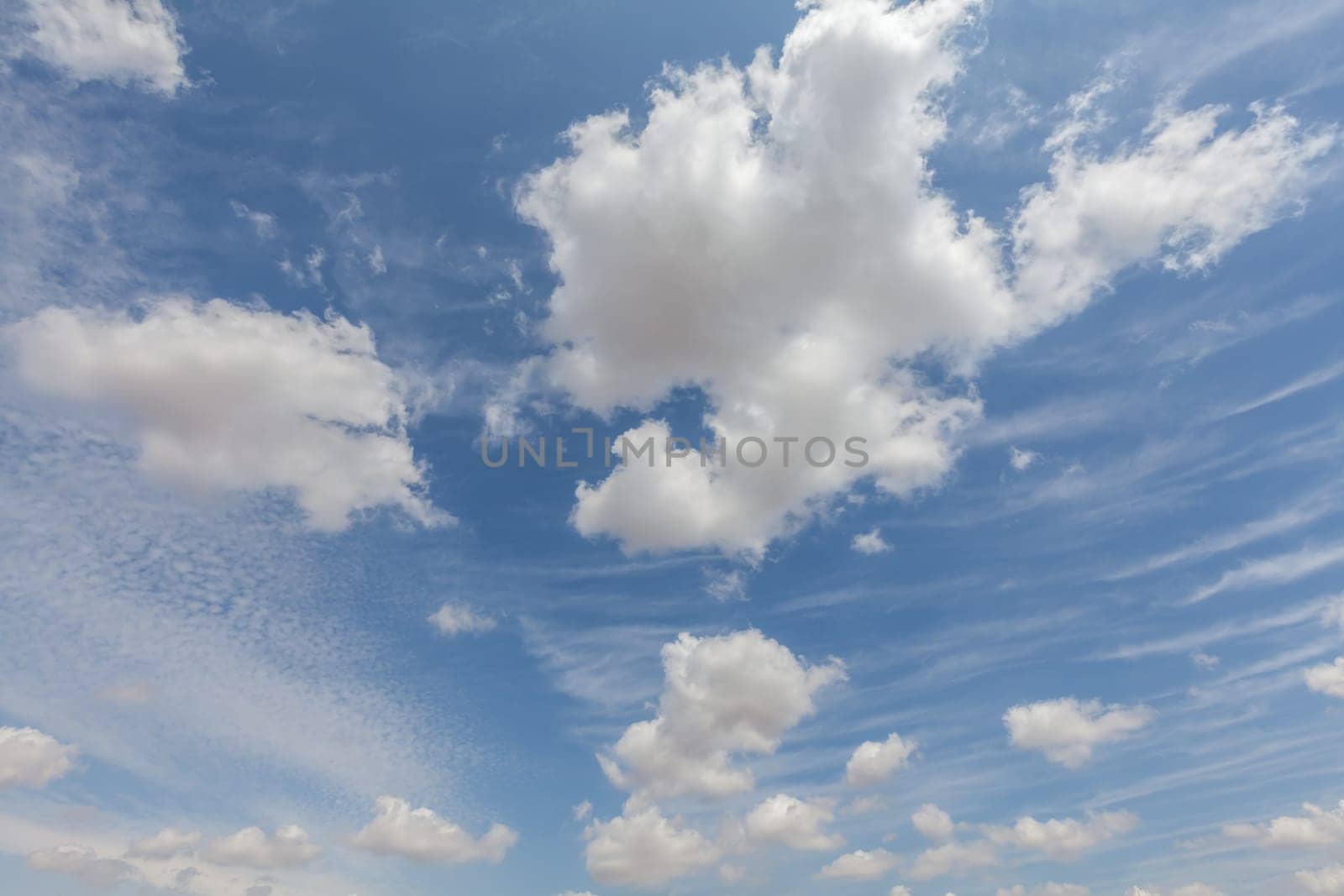 Beautiful white clouds and blue sky background over England UK. Fluffy and wispy cloudscape backdrop