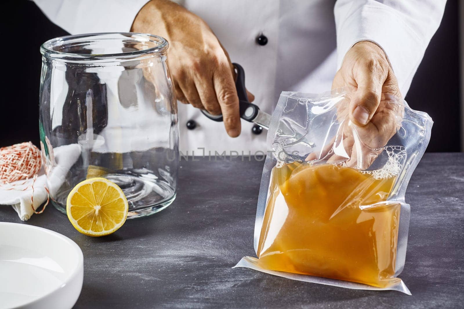 Man opening bag with symbiotic culture of bacteria and yeast to prepare kombucha tea