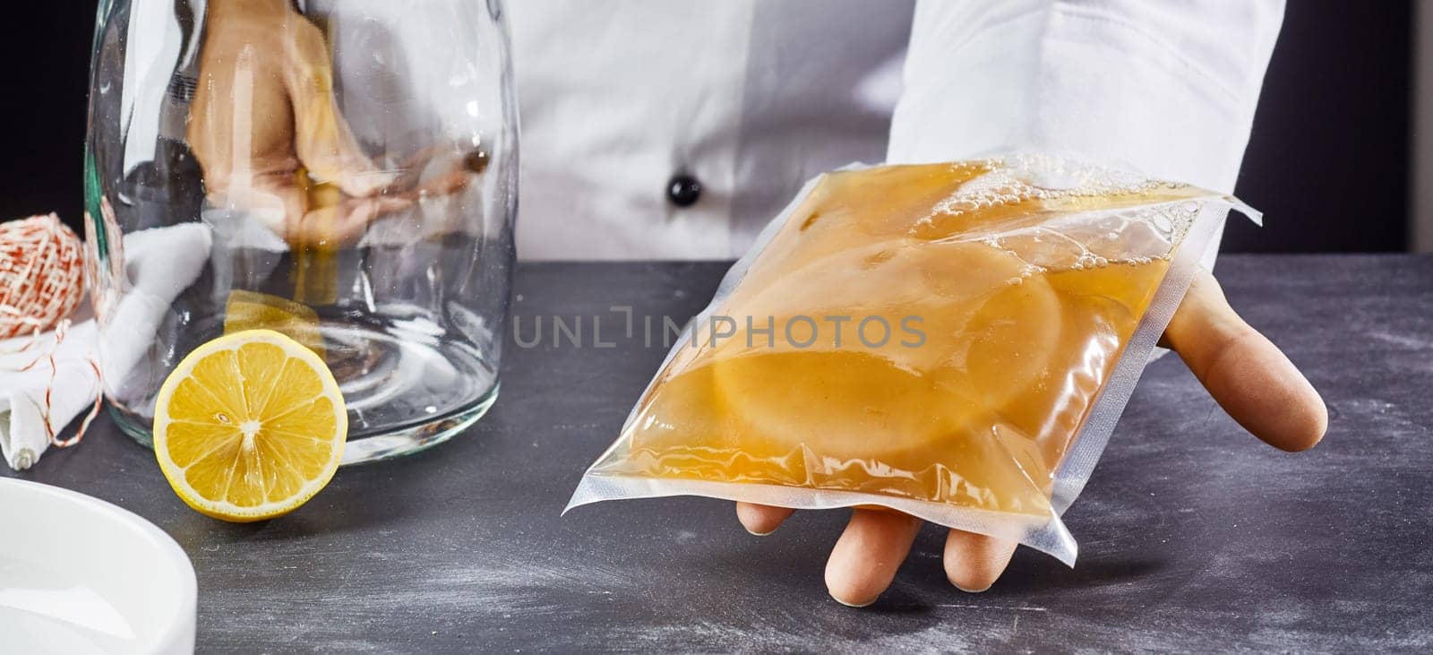 Man holding plastic bag with symbiotic culture of bacteria and yeast to prepare kombucha