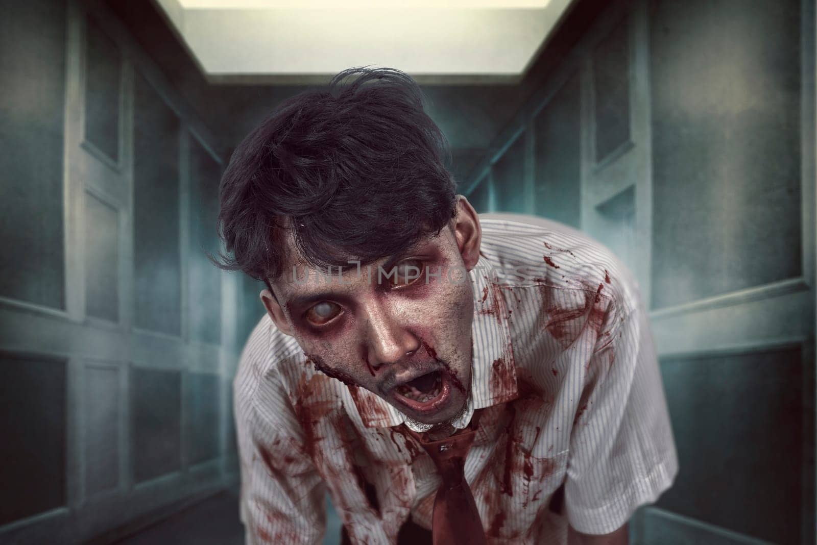 Spooky zombie man with bloody face on the dark place. Halloween concept