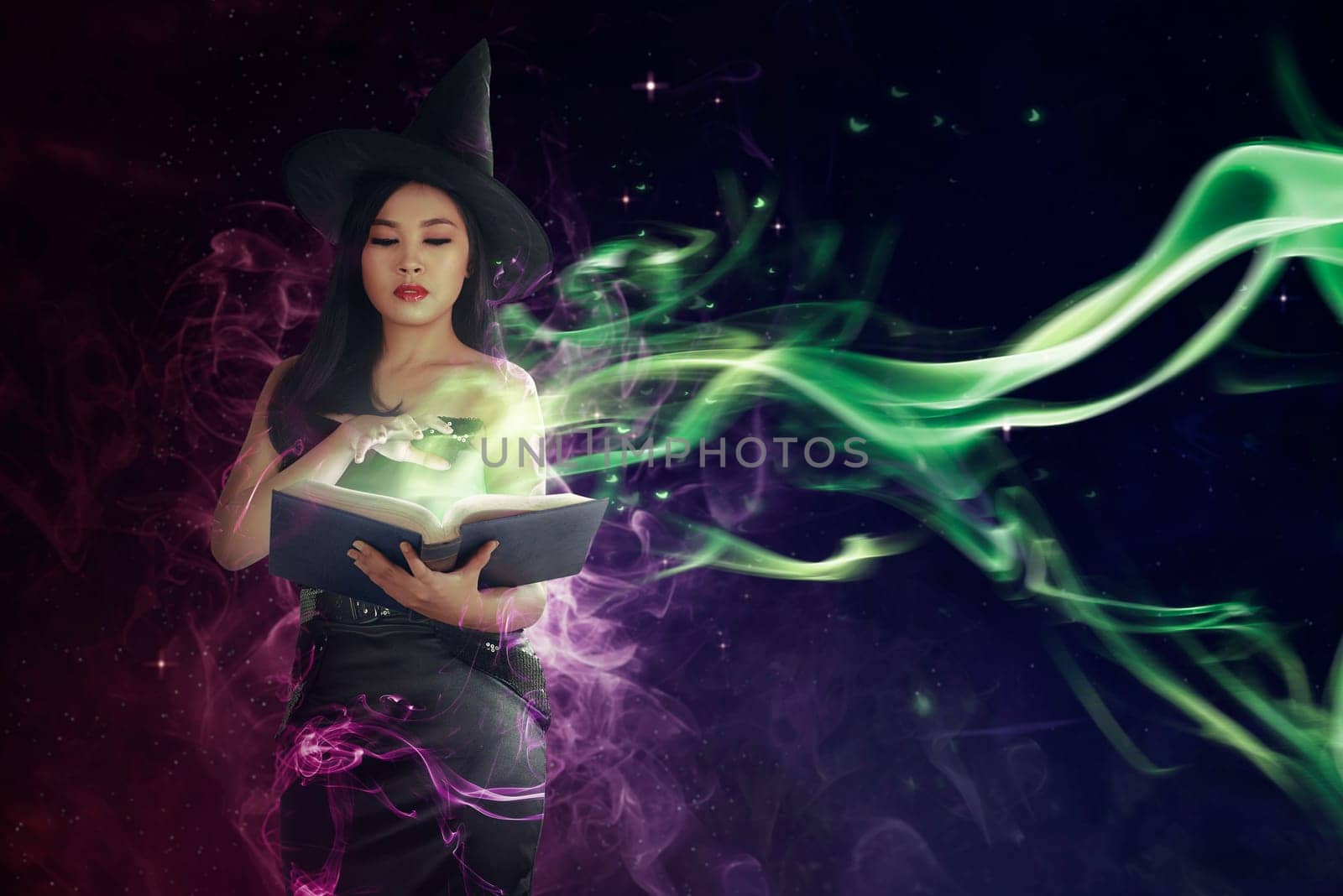Pretty asian witch woman reading the incantation in book. Halloween concept