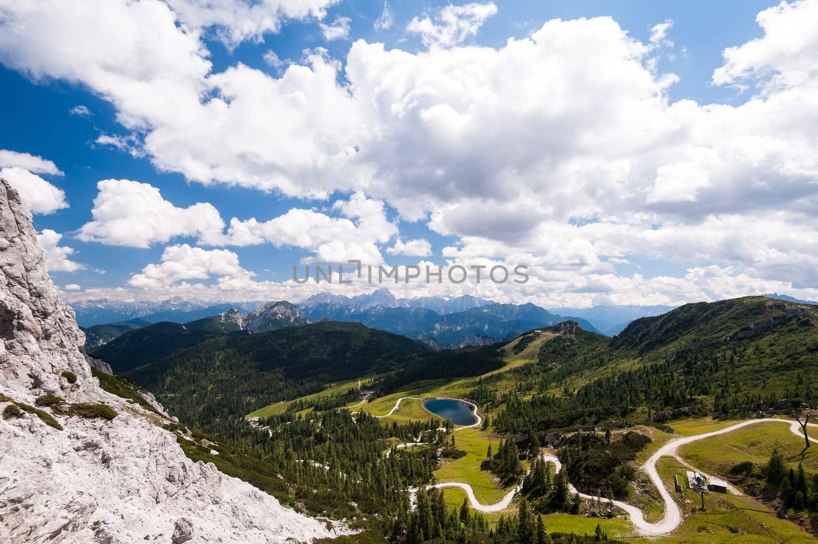 Mountain landscape with trail and green meadow and forest. Alps,Austria, Nassfeld