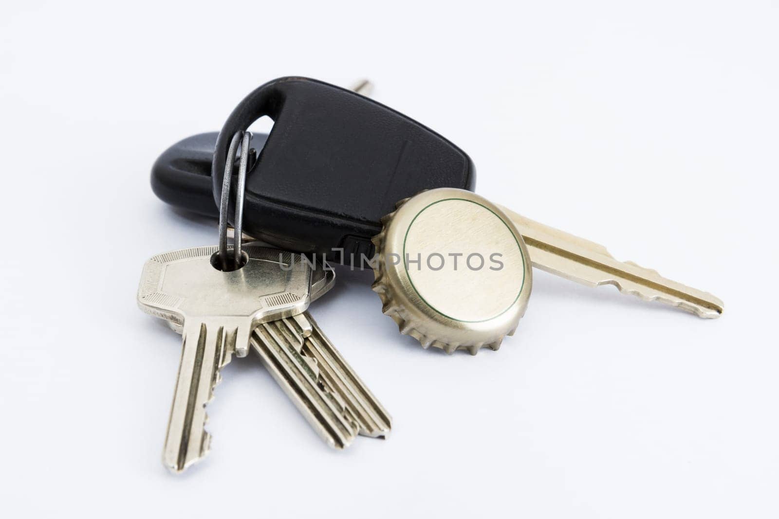 car key and bottle cap in close up with neutral grey background
