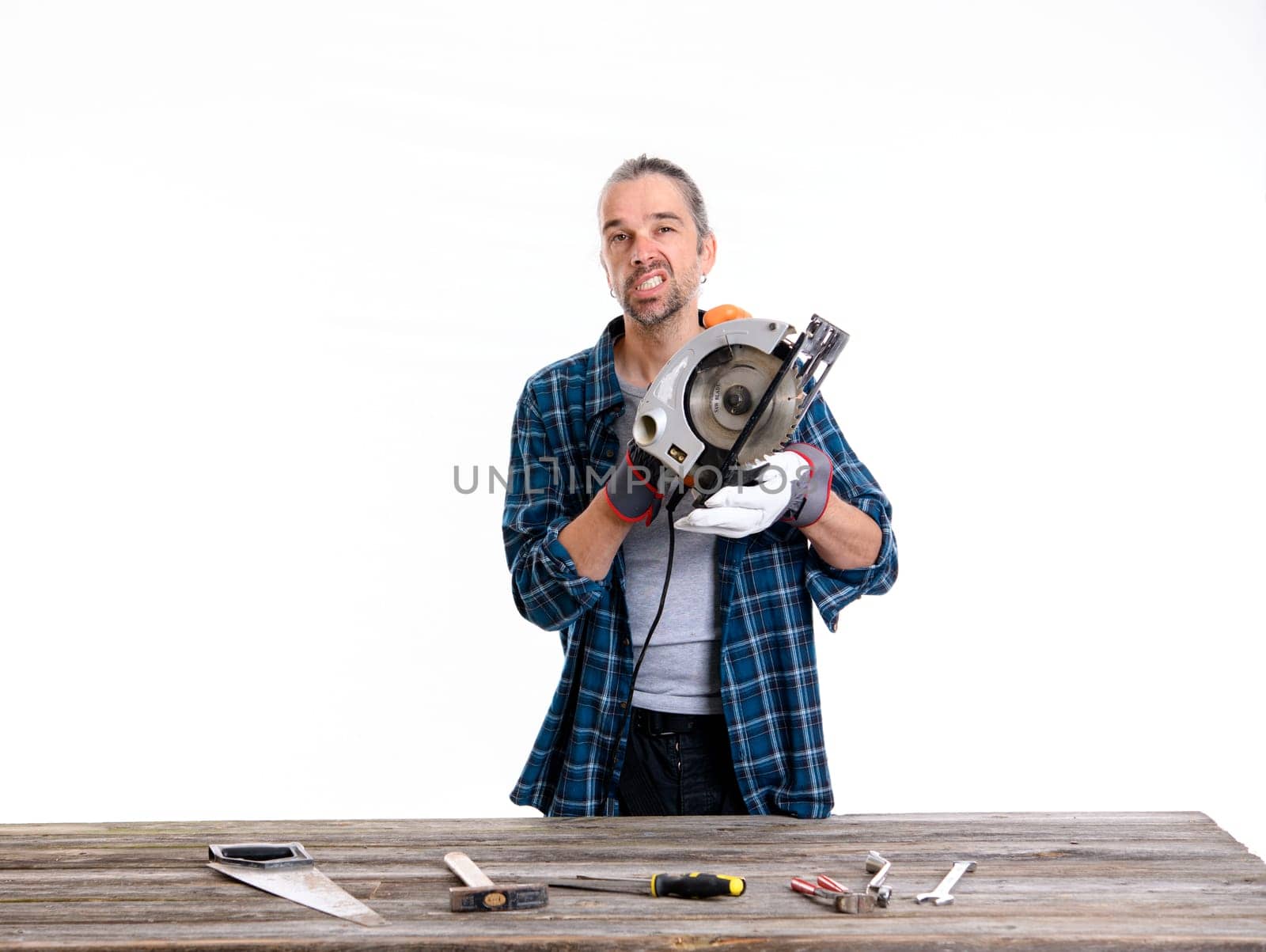 funny worker in blue plaid shirt working with wood