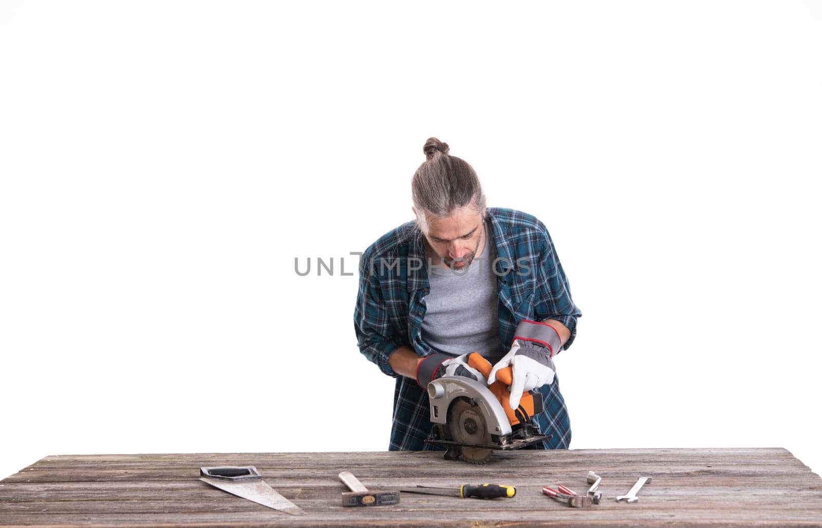 worker in blue plaid shirt working with wood