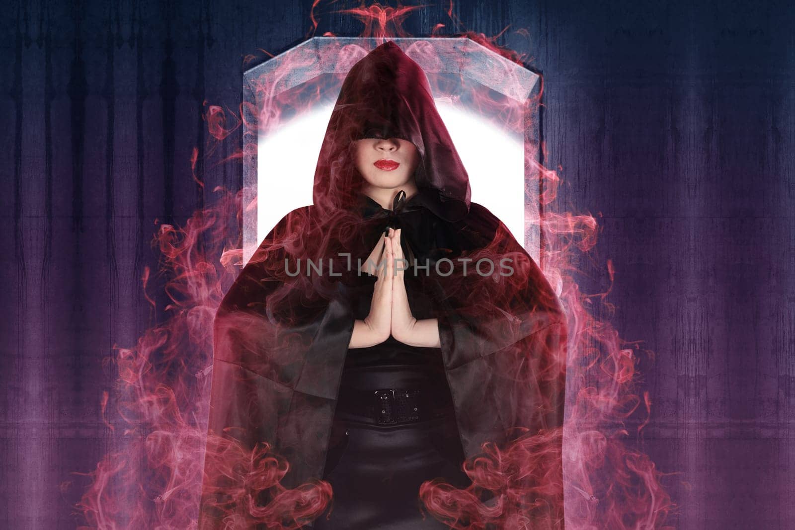 Attractive witch woman showing her magic power with wall background