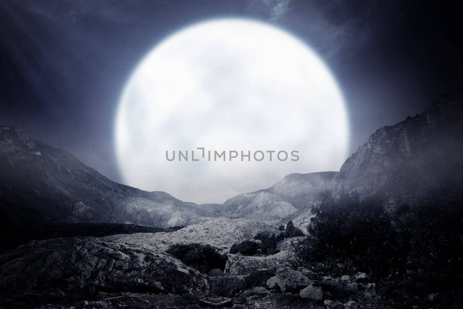 Foggy rocky mountain with moonlight background