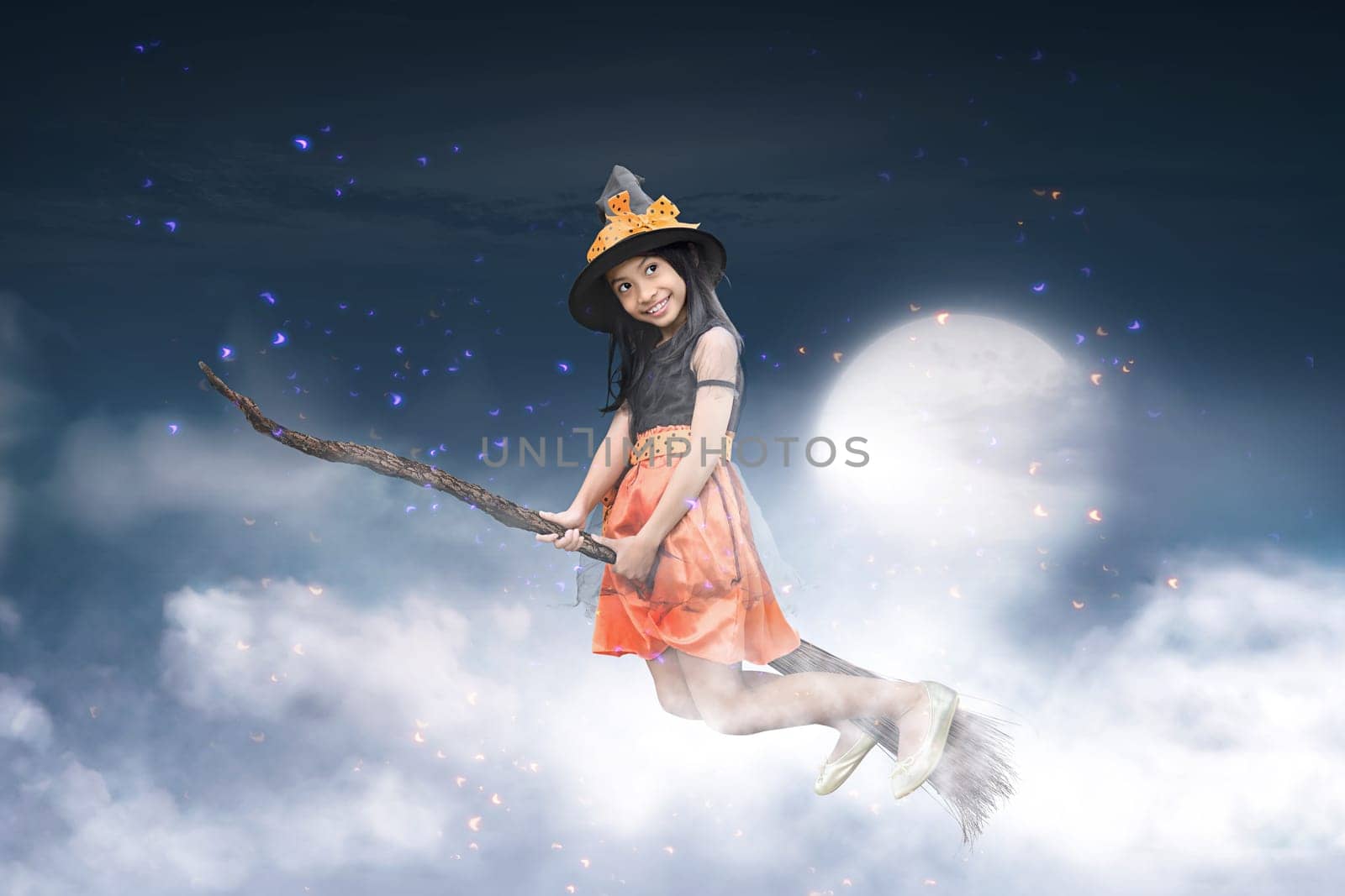 Happy asian witch girl flying on broomstick with moonlight background
