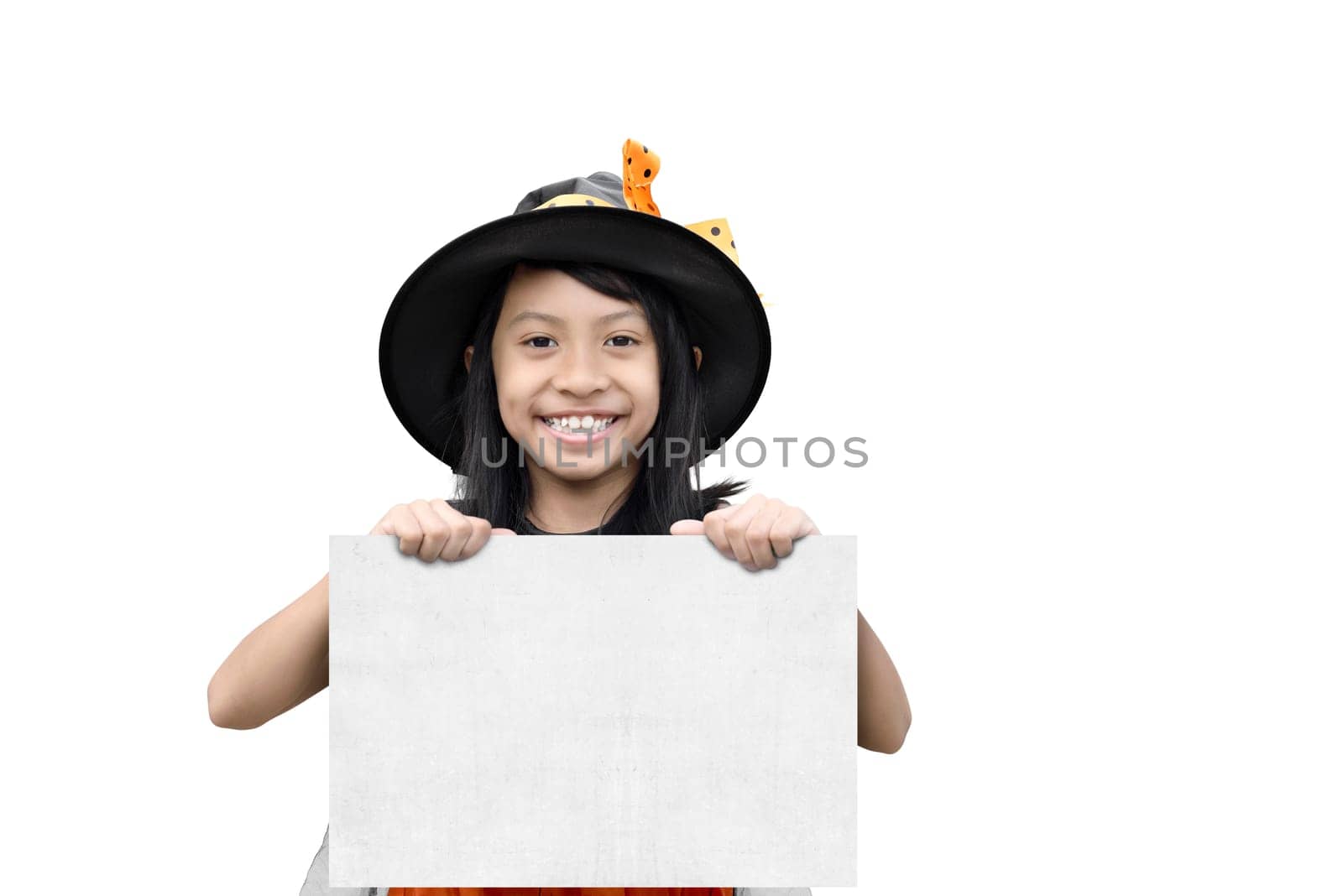 Happy asian witch girl holding white paper for copy space isolated over white background