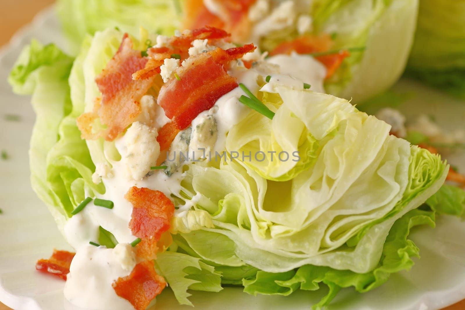 Wedge of lettuce with blue cheese dressing and bacon