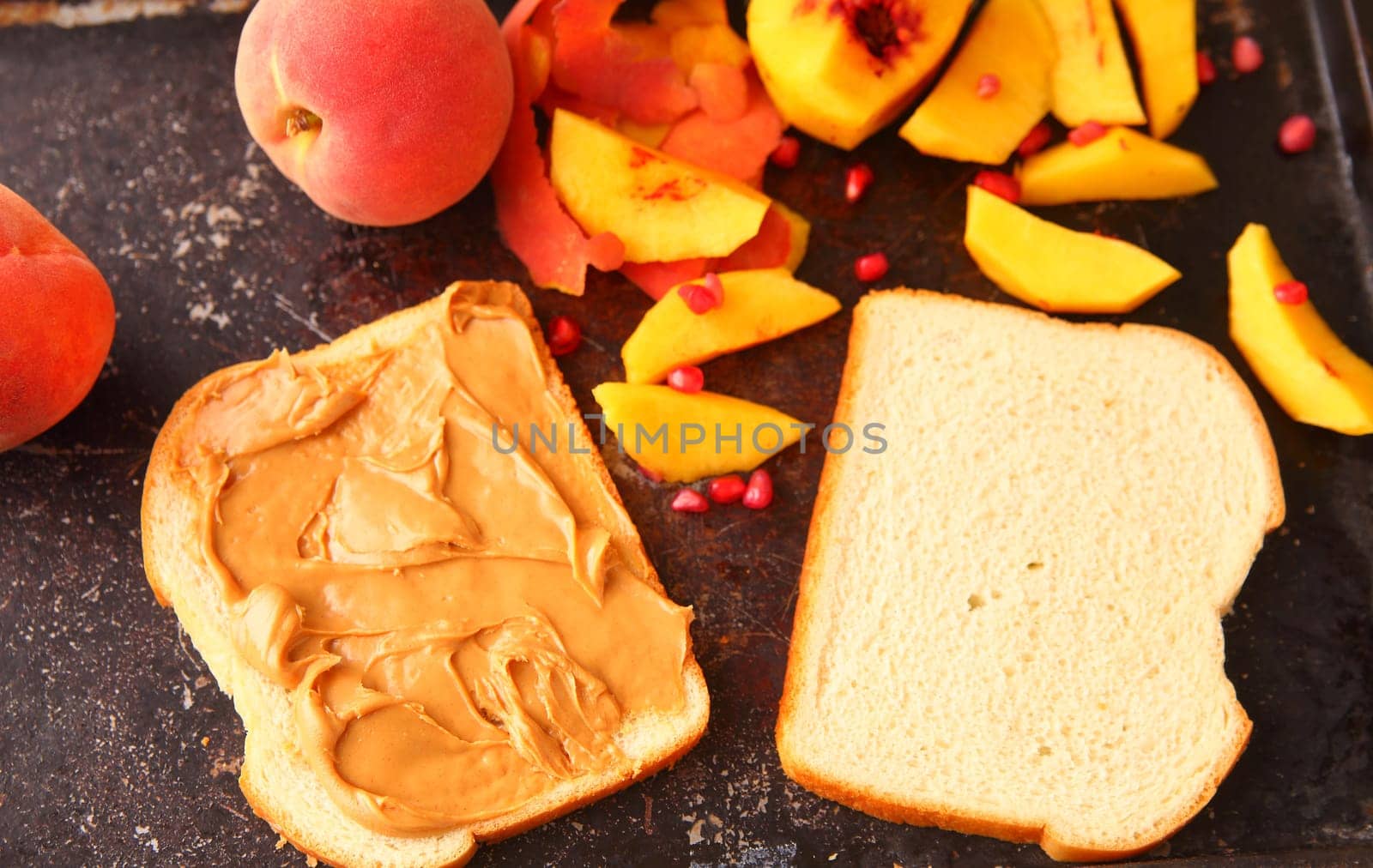 Making a sandwich with fresh fruit and pomegranate seeds