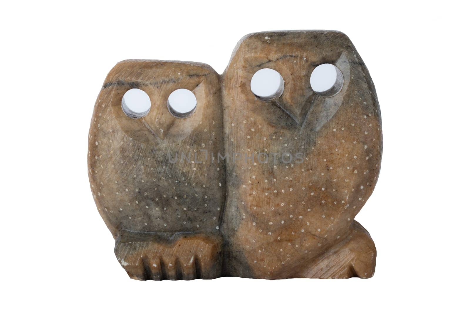 Owls isolated. Two owls handmade of soapstone with holes as eyes isolated on white background.