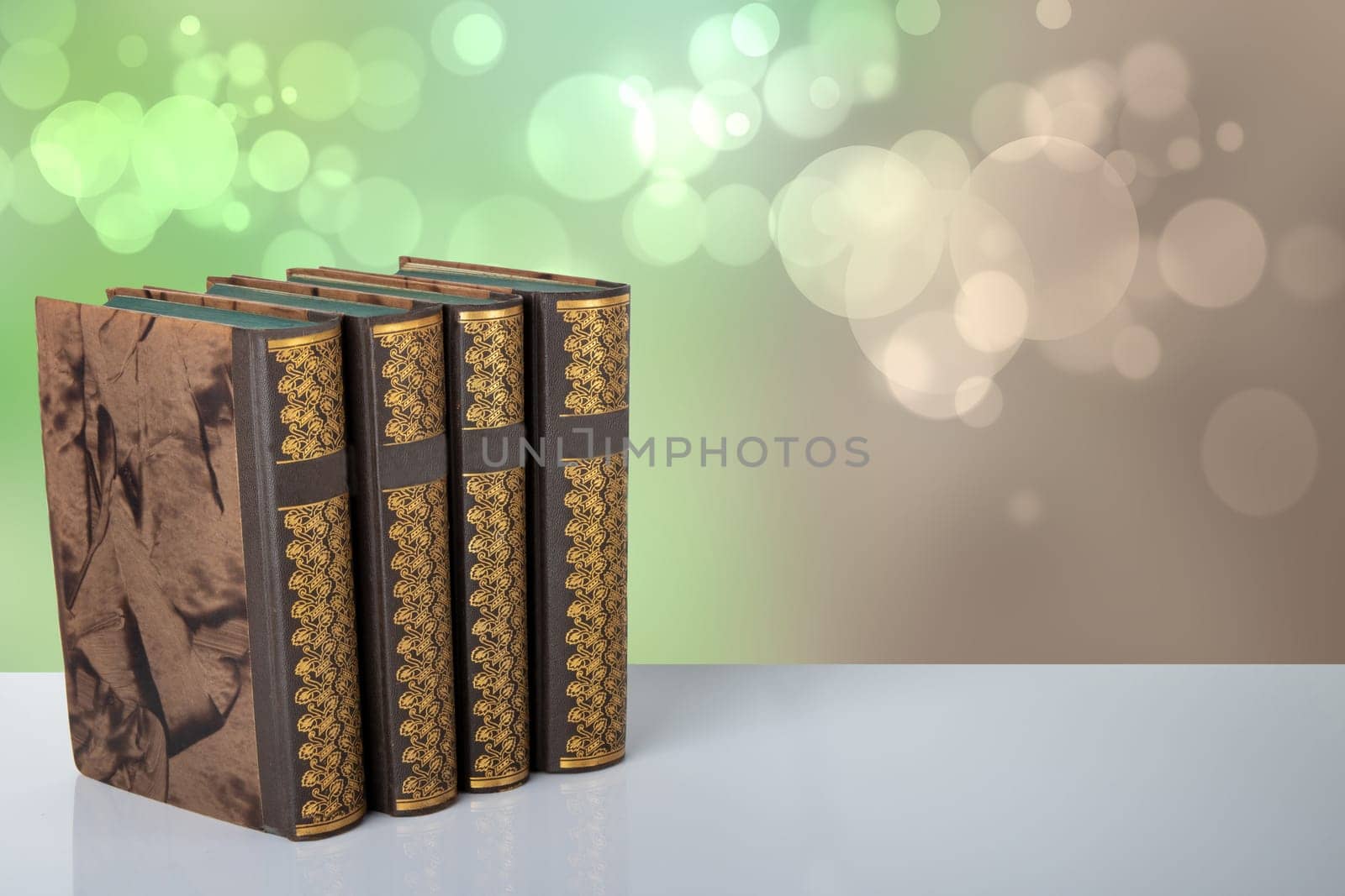 Old books on table with bright bokeh background. Space for your product display montage. Concept education.