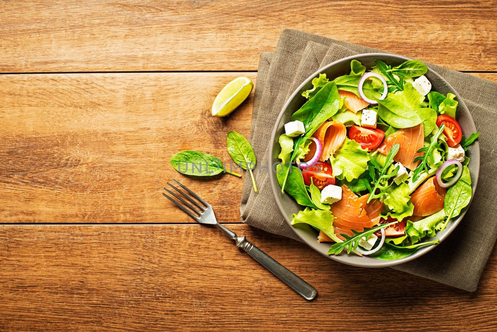 Fresh green salad with smoked salmon and cheese