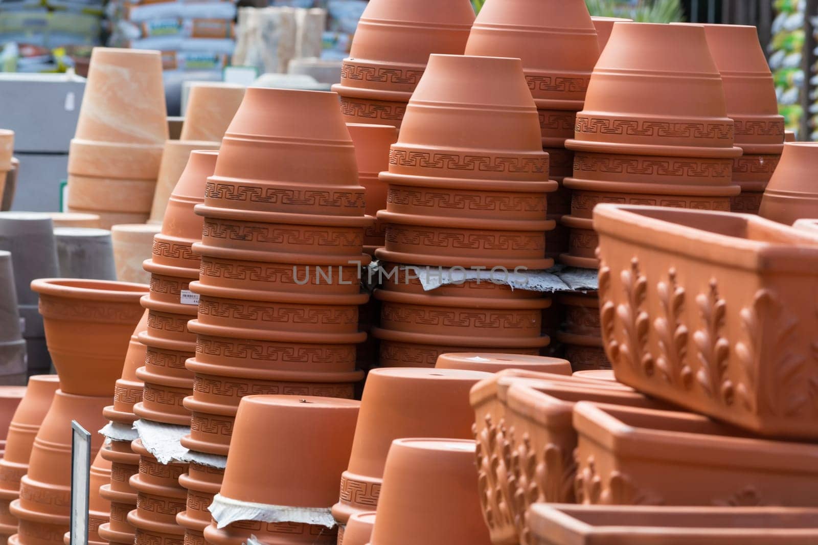 Terracotta pots for sale on shelf in the garden center shop