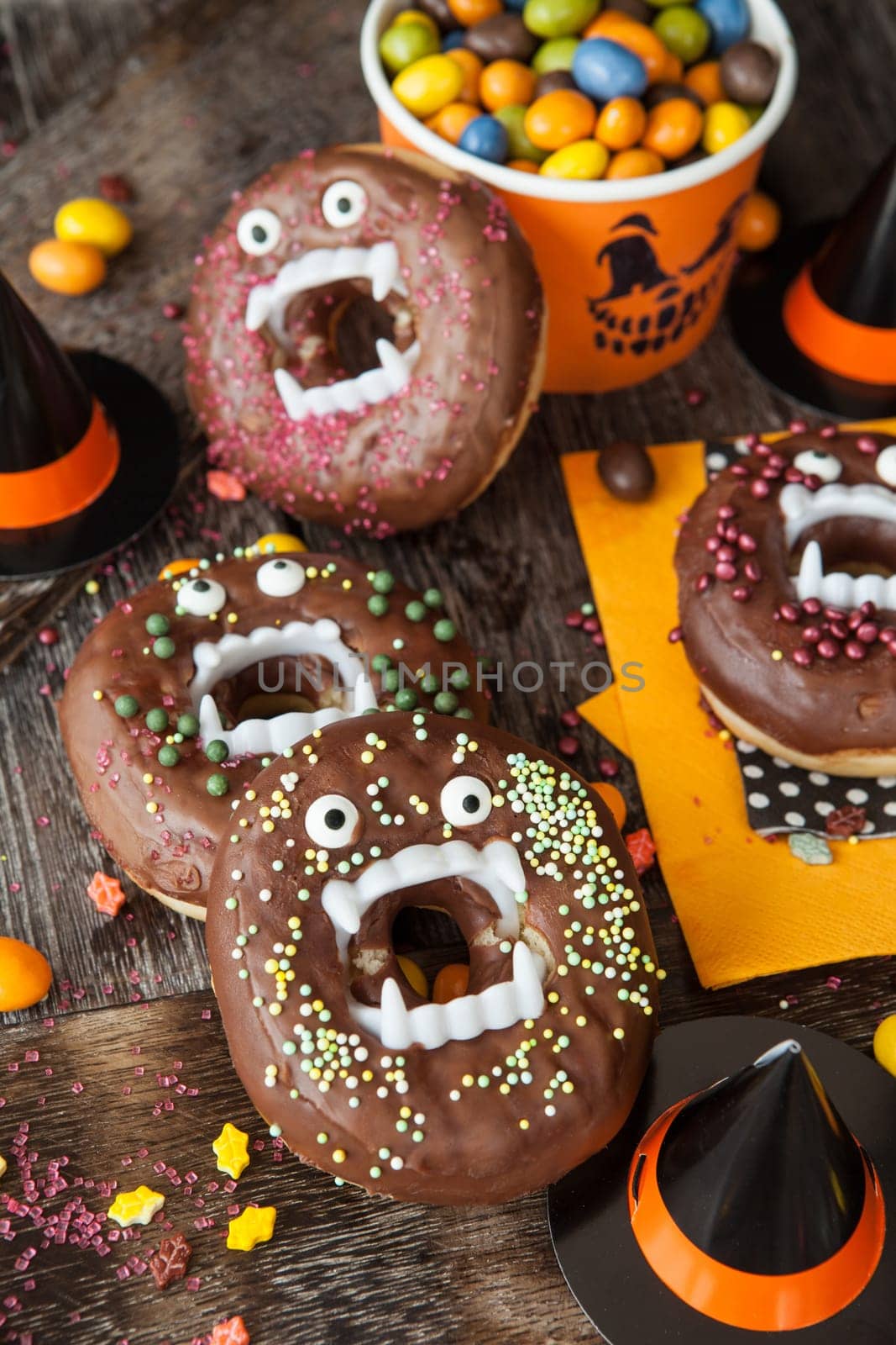 Scary Halloween donuts with chocolate frosting and sugar sprinkles