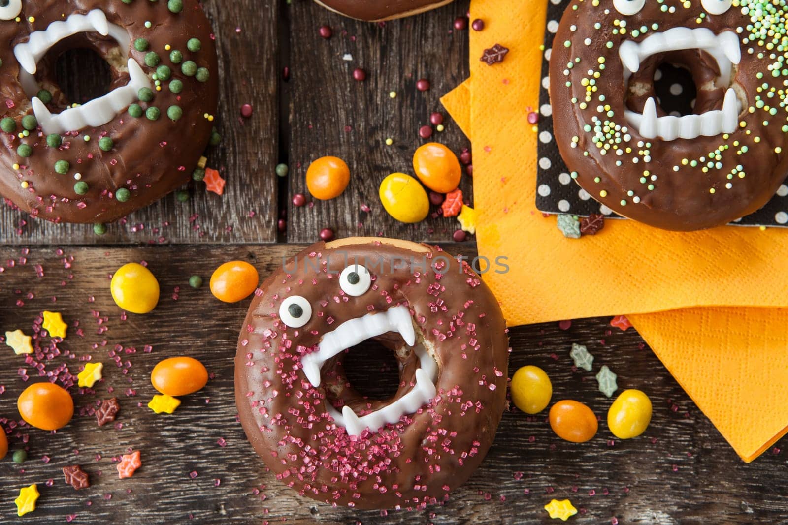 Scary Halloween donuts with chocolate frosting and sugar sprinkles