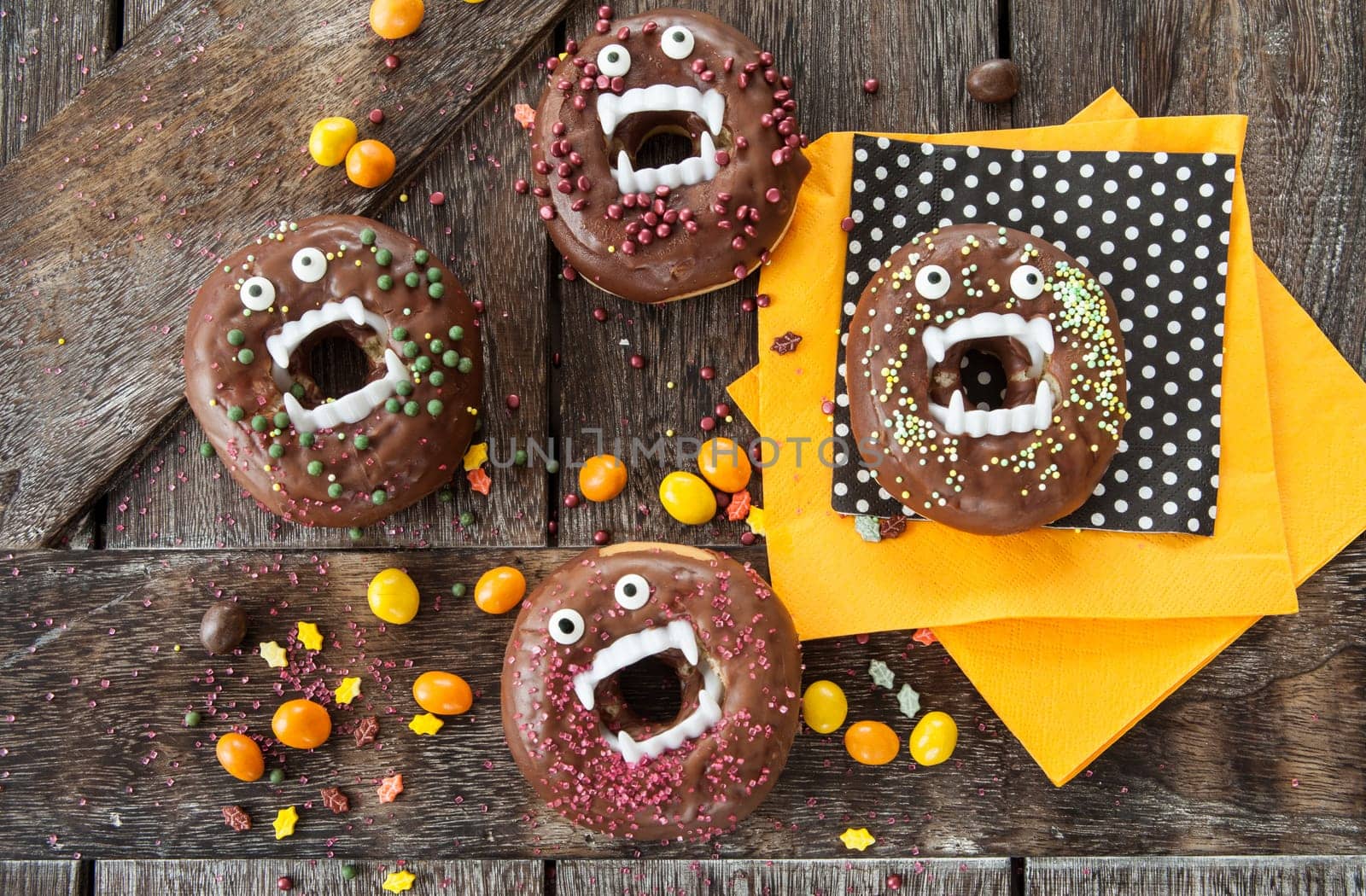 Scary Halloween donuts with chocolate frosting and sugar sprinkles