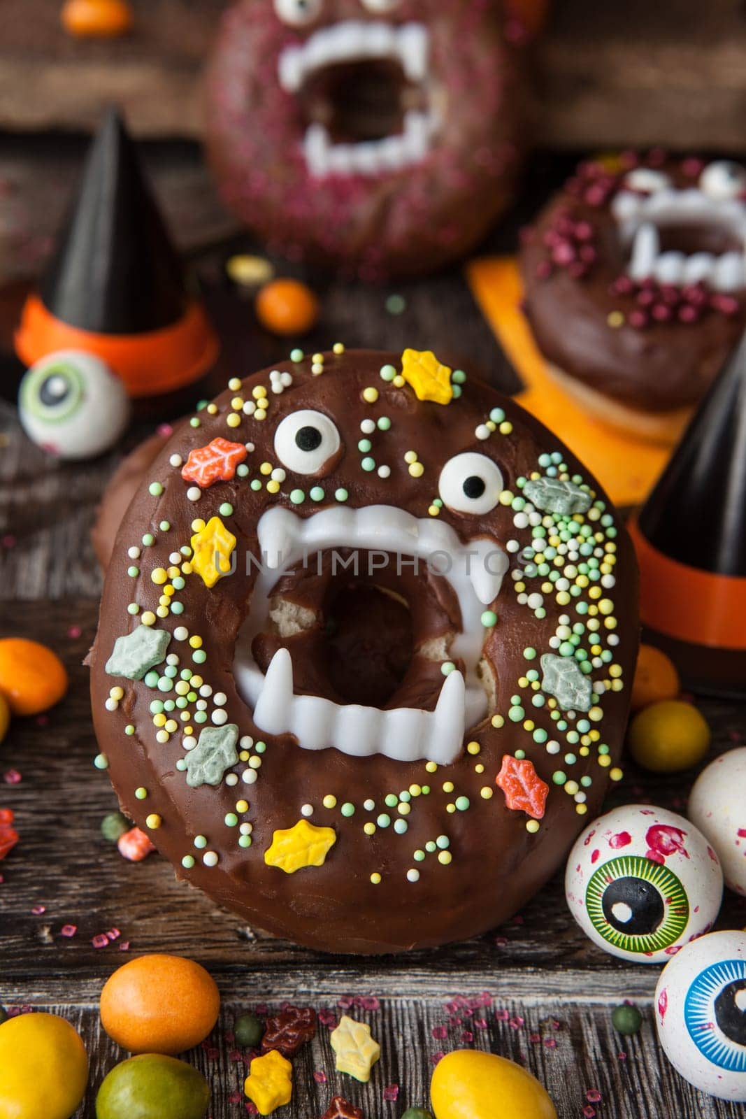 Scary Halloween donuts with chocolate frosting and sugar sprinkles