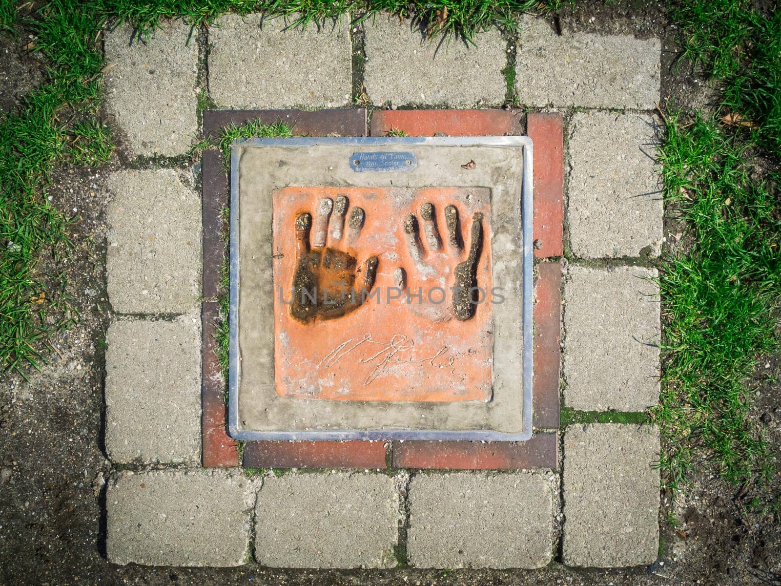 Carolinensiel, Germany - April 16, 2018: Handprint of former national player Uwe Seeler in a memorial plate on the ground in the port of Carolinensiel.