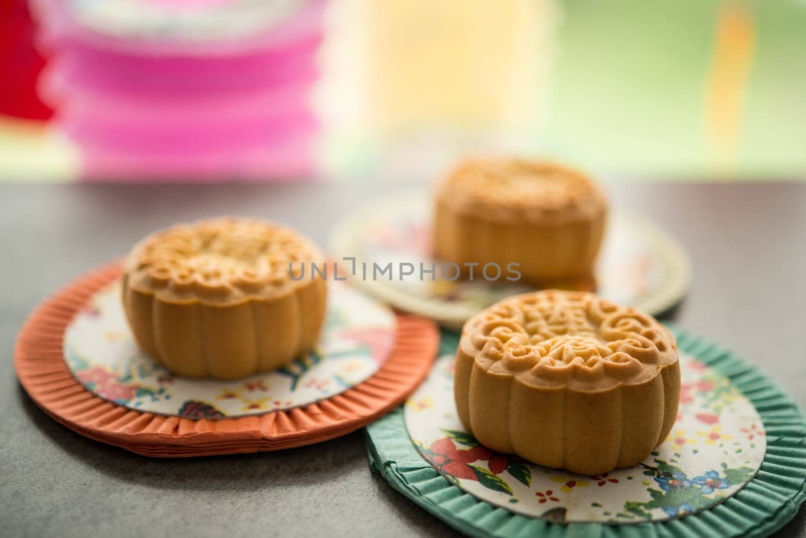 Mooncakes is traditionally pastry to eaten during Mid-Autumn Festival. Lanterns at background. The Chinese character represent "lotus paste"" in English."