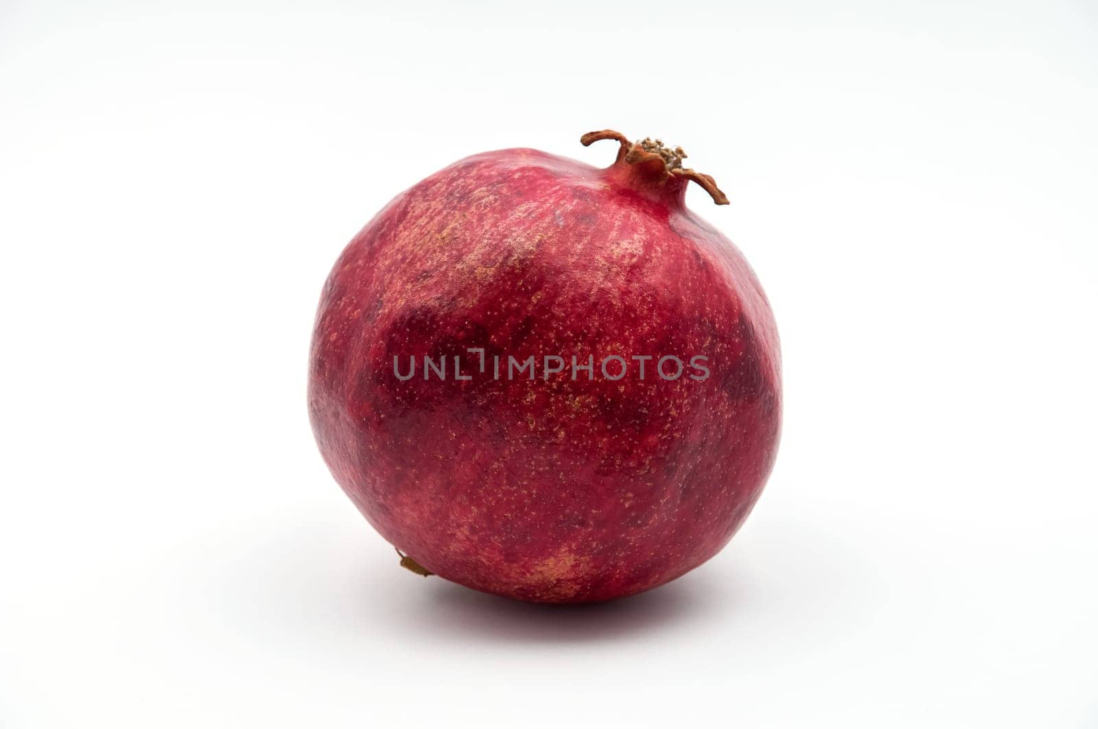 Fruit of a pomegranate of red color on a white background