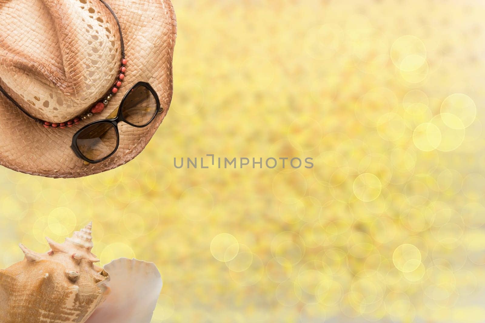Summer fashion, straw hat, sun glasses and sea shell on illustrated yellow sandy beach. Travel and vacations concept. Holiday season.