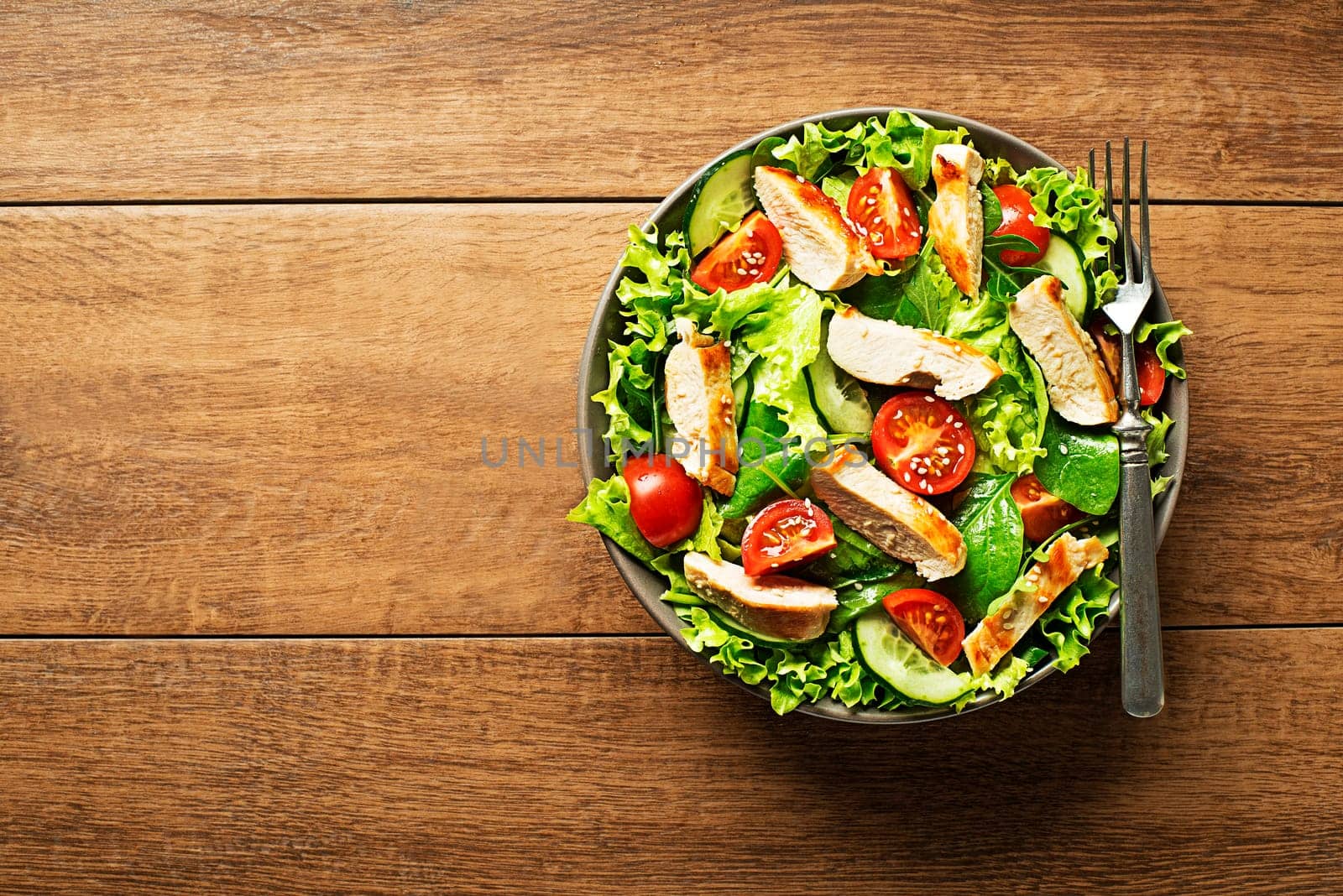 Fresh green salad with chicken breast and tomato