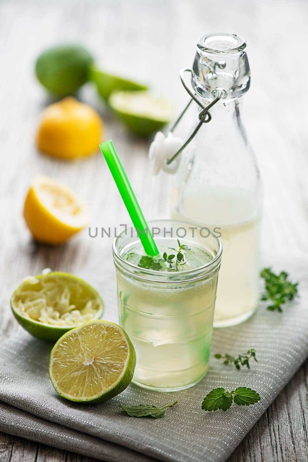 Lemonade or mojito cocktail with lemon and mint, cold refreshing drink or beverage with ice