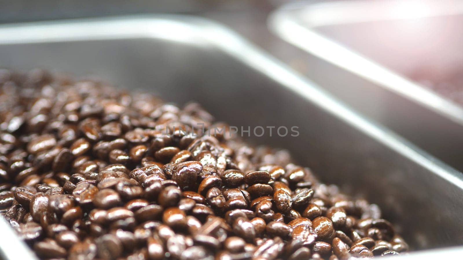 Many coffee beans from excellent source around the World in silver metal tray which special hand made roasted for barista bring a good aroma taste of freshness to their customer.