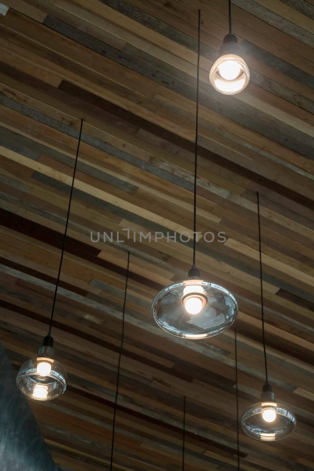 Vintage light bulbs hanging from ceiling, stock photo