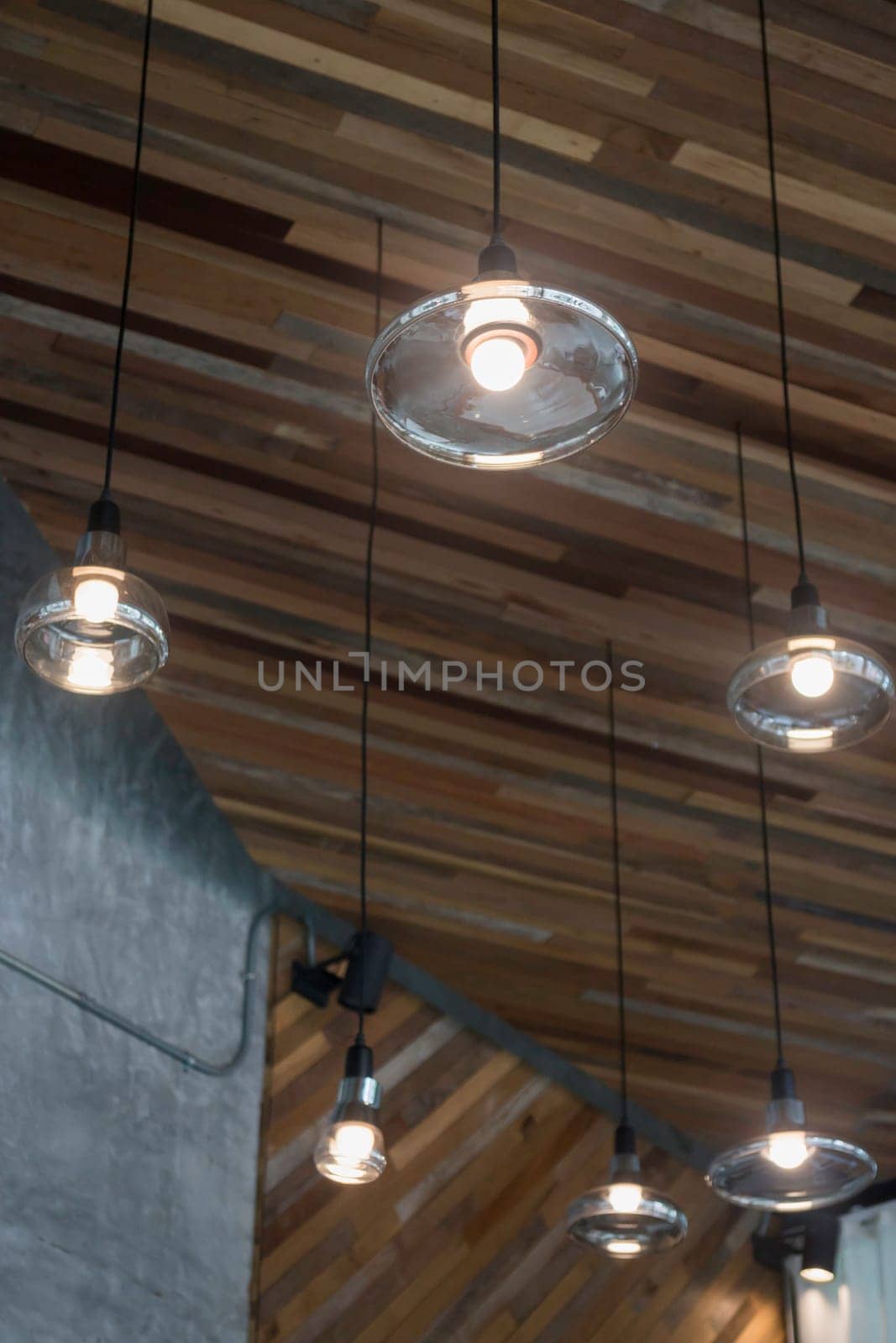 Vintage light bulbs hanging from ceiling, stock photo