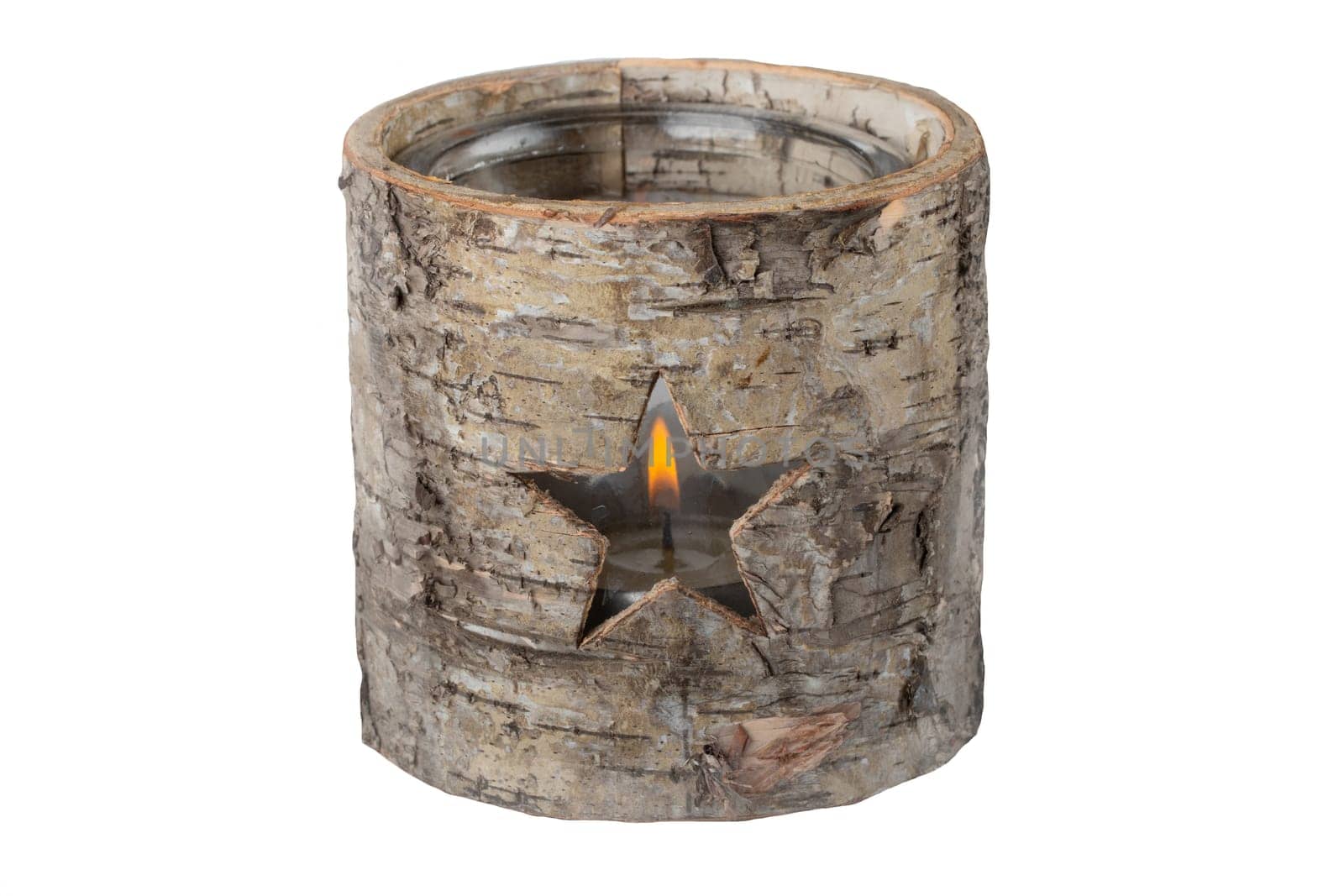 Decorative tea light as a star in wooden tree stump. Christmas time.